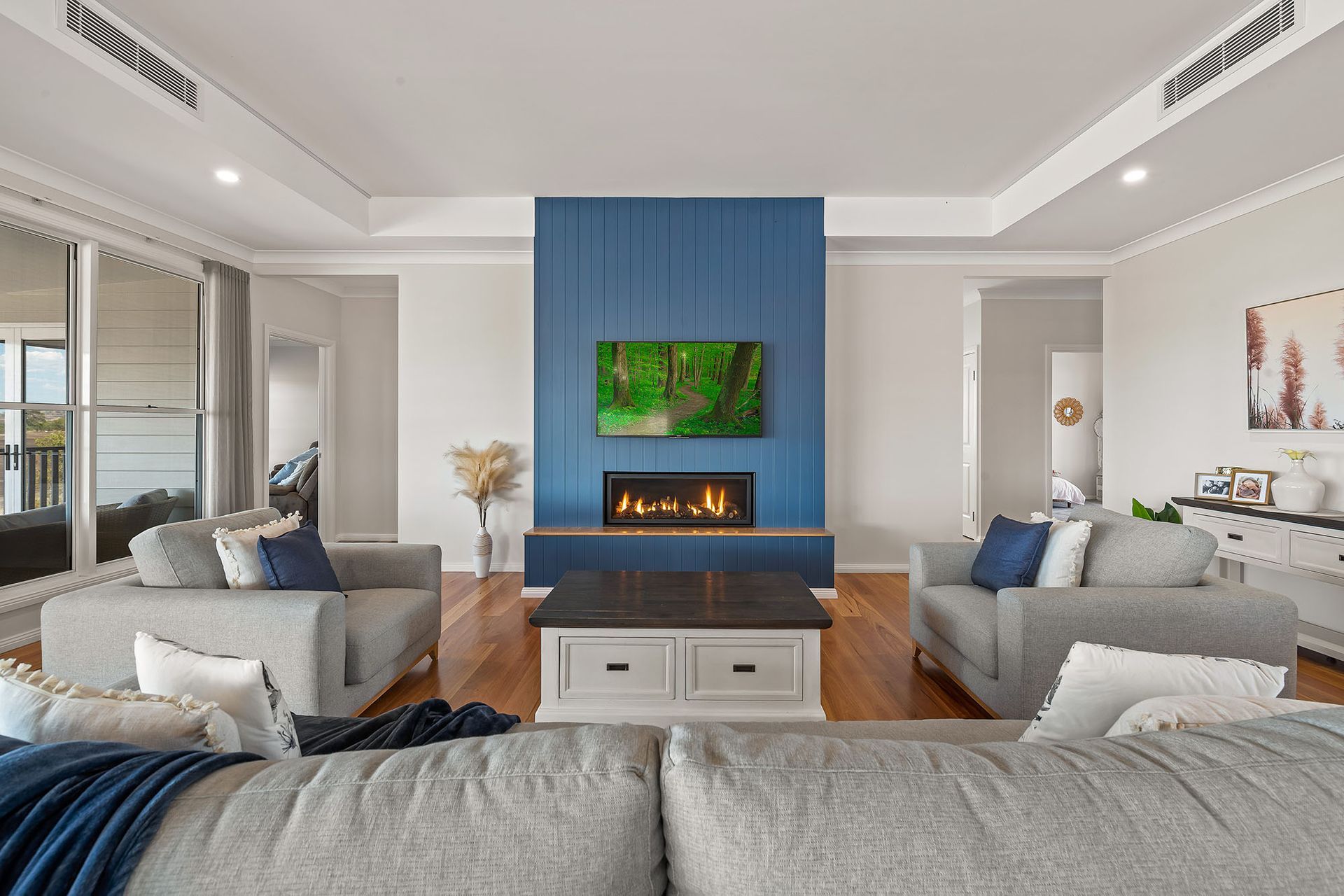 there is a fireplace in the middle of the living room .