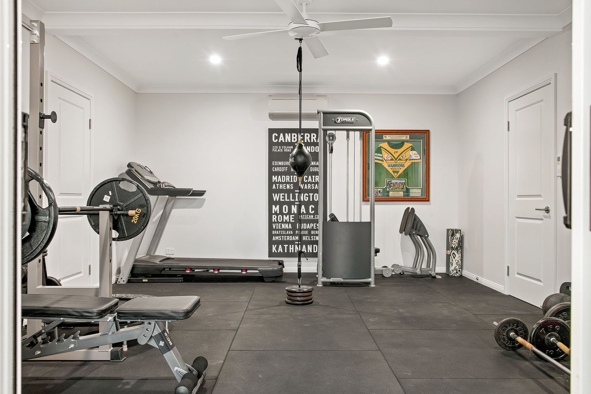 a home gym with grey flooring
