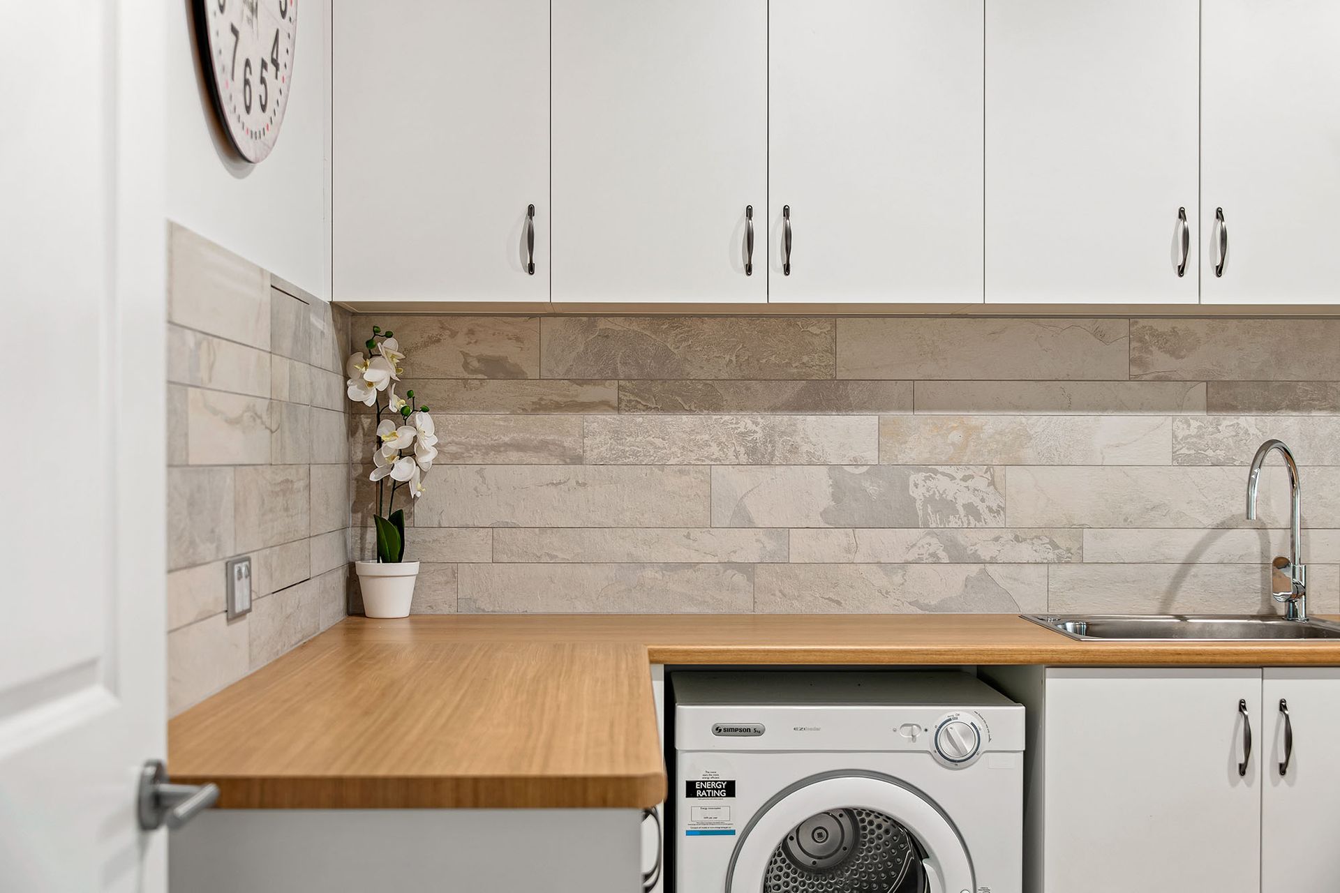 there is a washing machine and dryer in the laundry room .