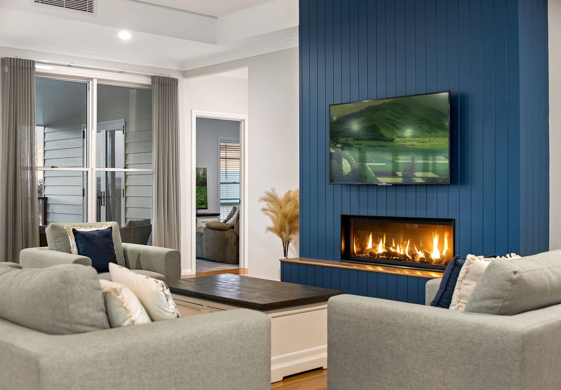 a living room with a fireplace and a flat screen tv .