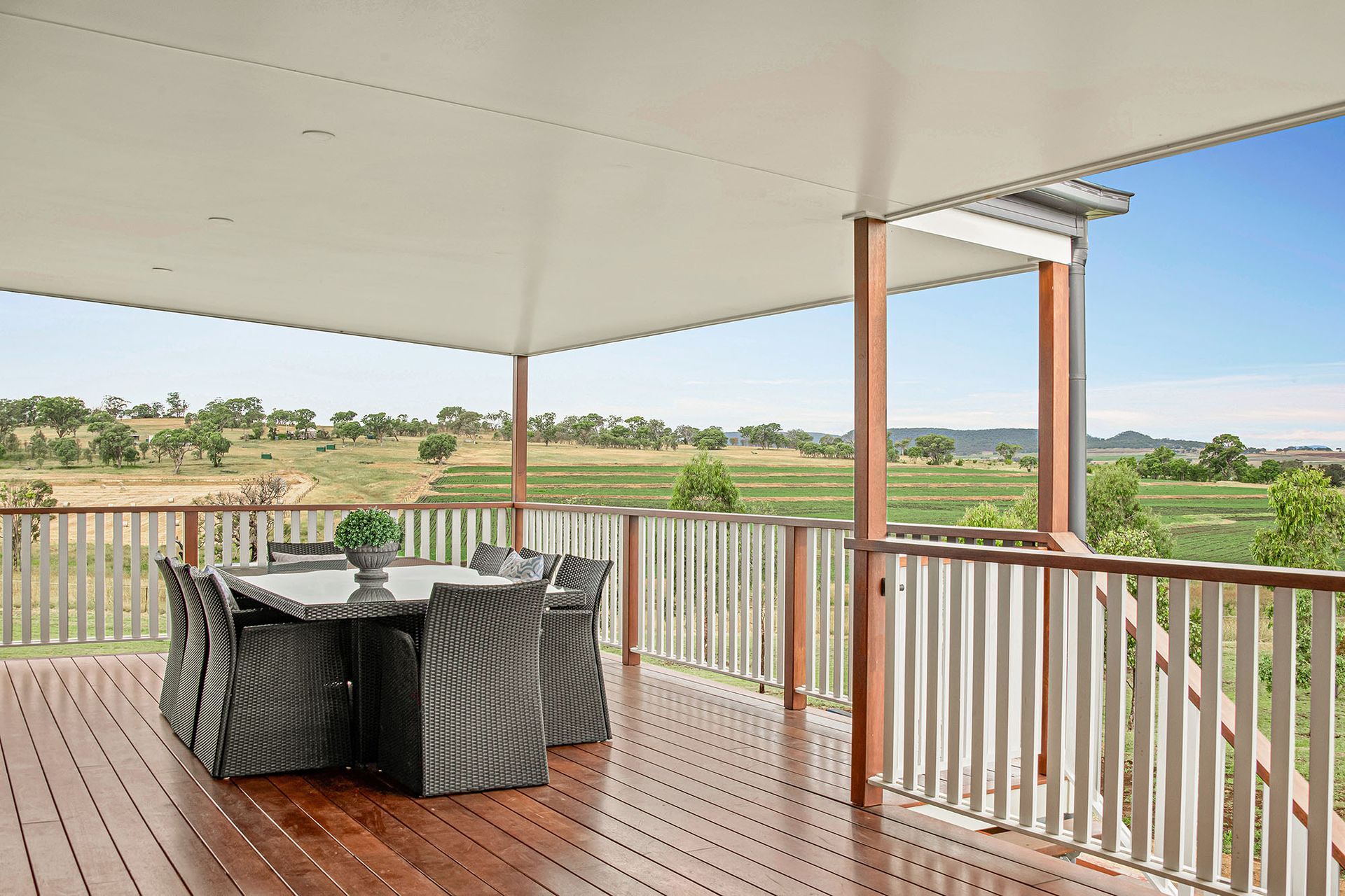 a wooden deck with a table and chairs on it .