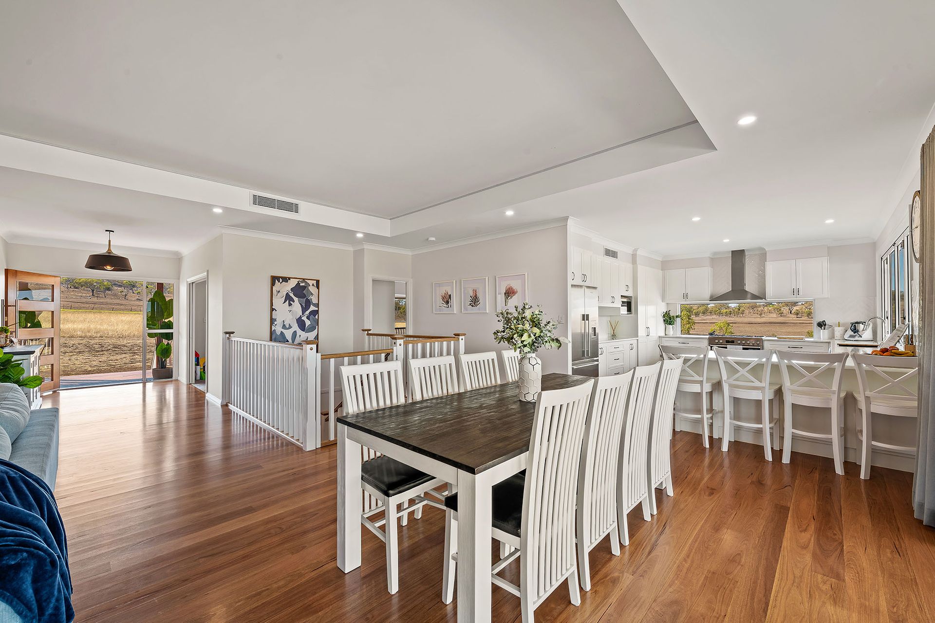 there is a dining table and chairs in the middle of the room .