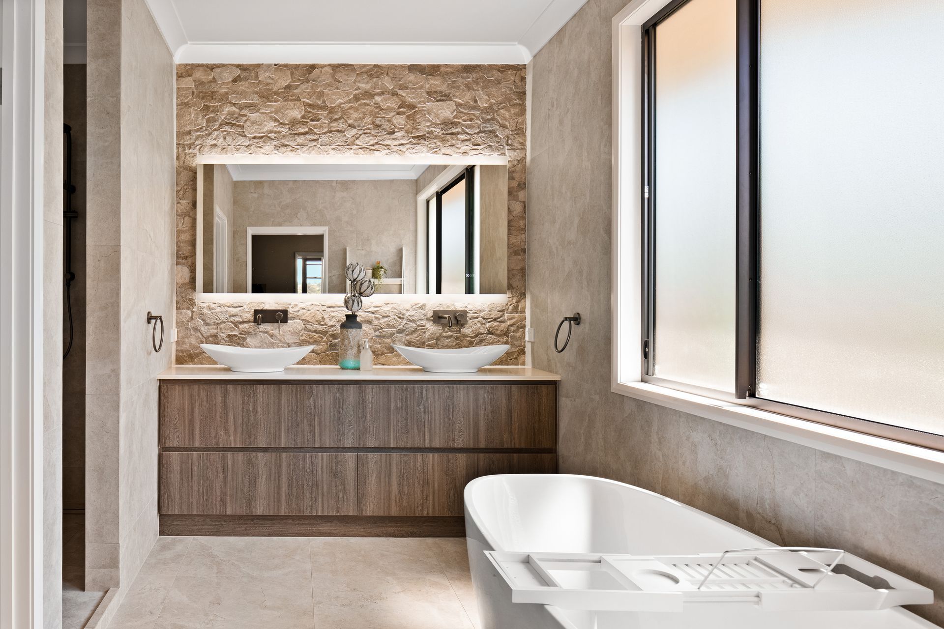 a bathroom with two sinks and a bathtub .