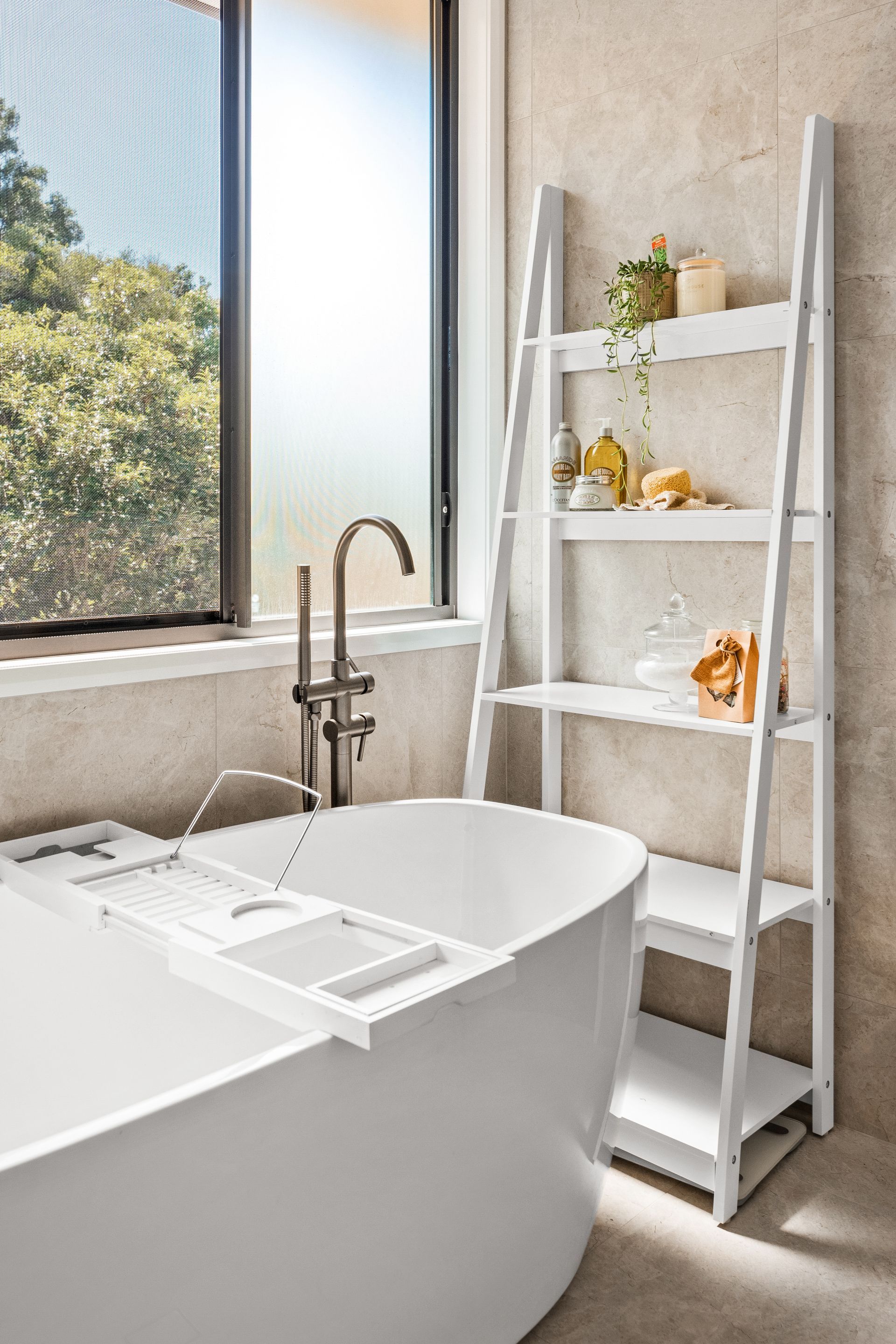 a bathroom with a bathtub and a ladder .