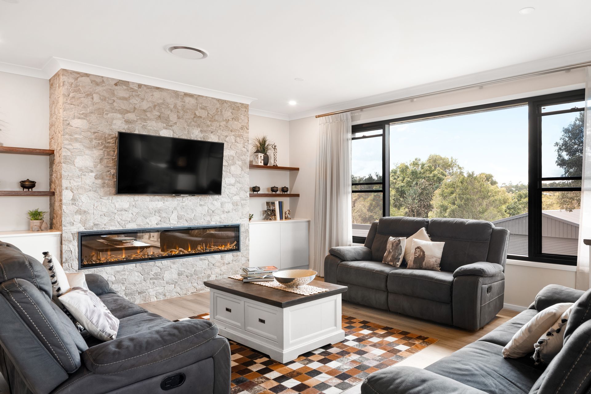 a living room filled with furniture and a flat screen tv .