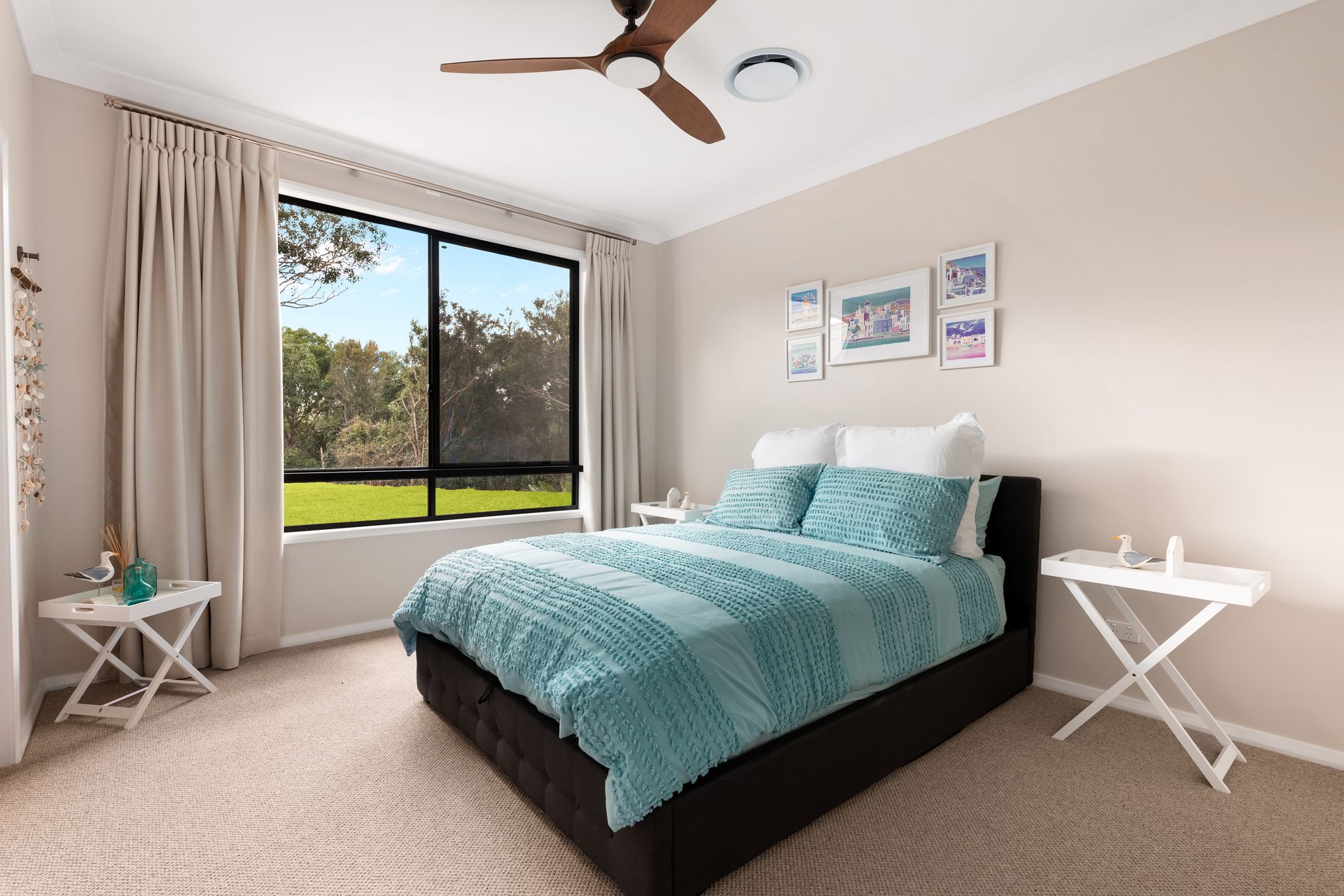 a bedroom with a bed , two nightstands and a ceiling fan .