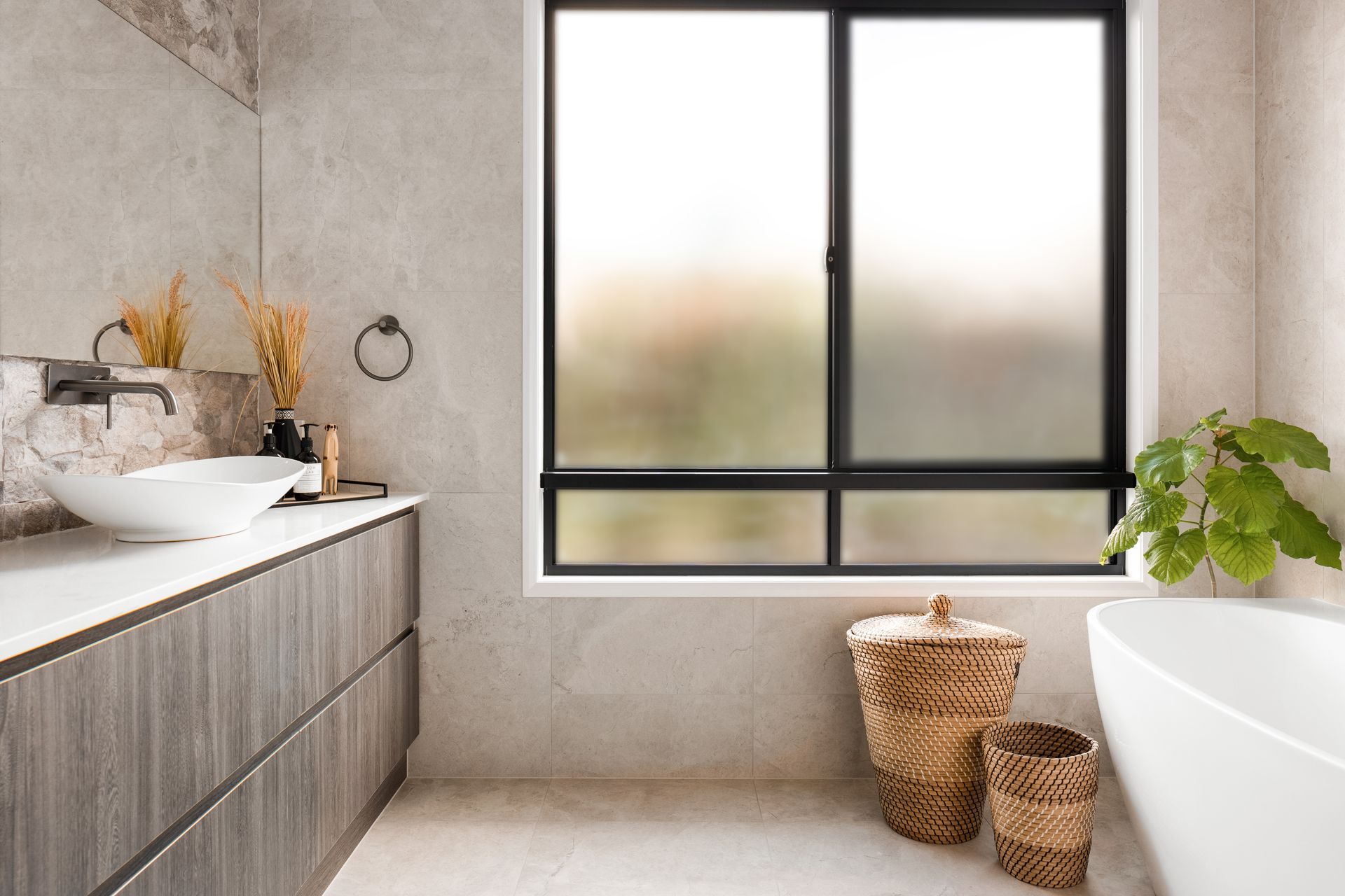 a bathroom with a sink , tub , and window .