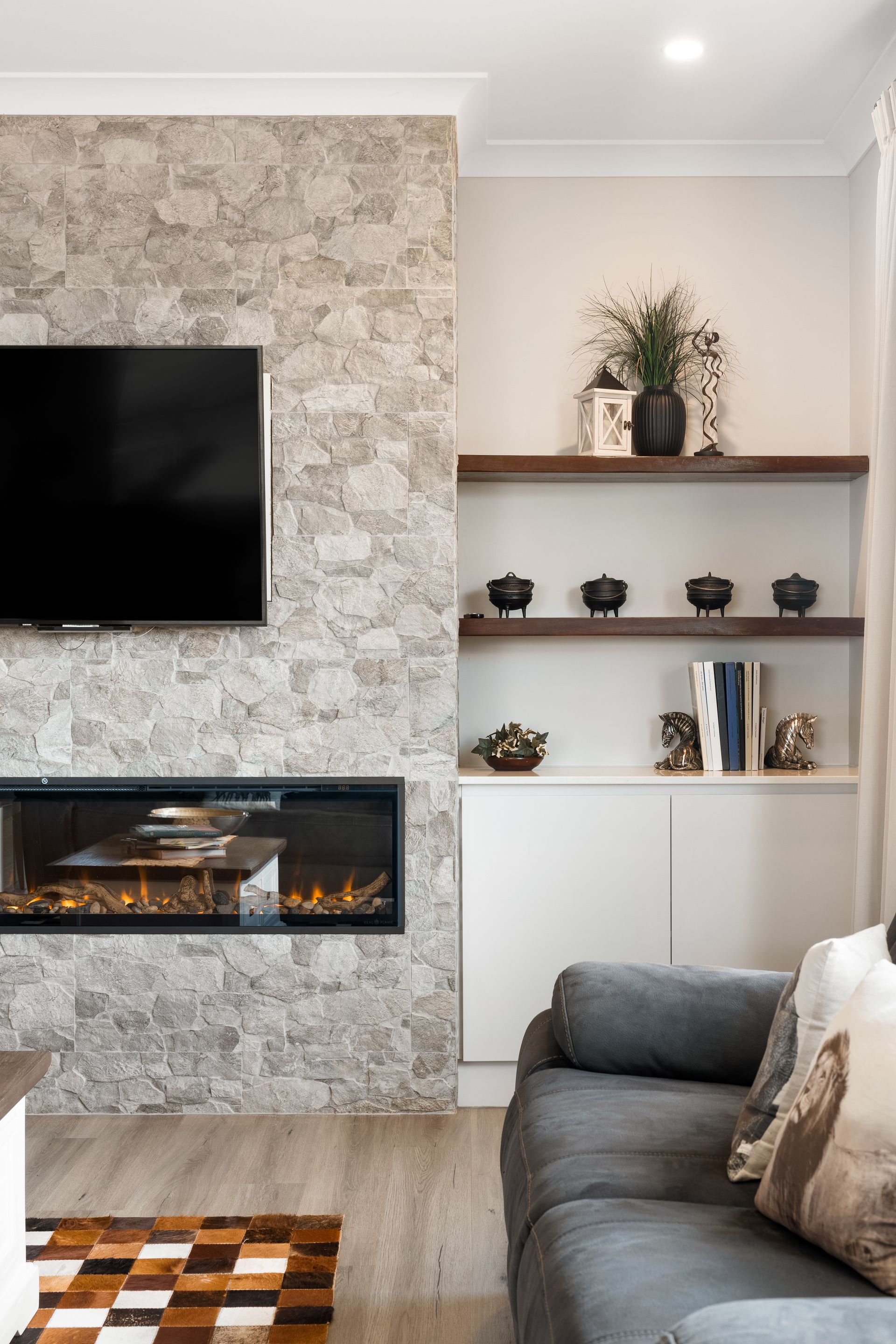 a living room with a fireplace and a flat screen tv .