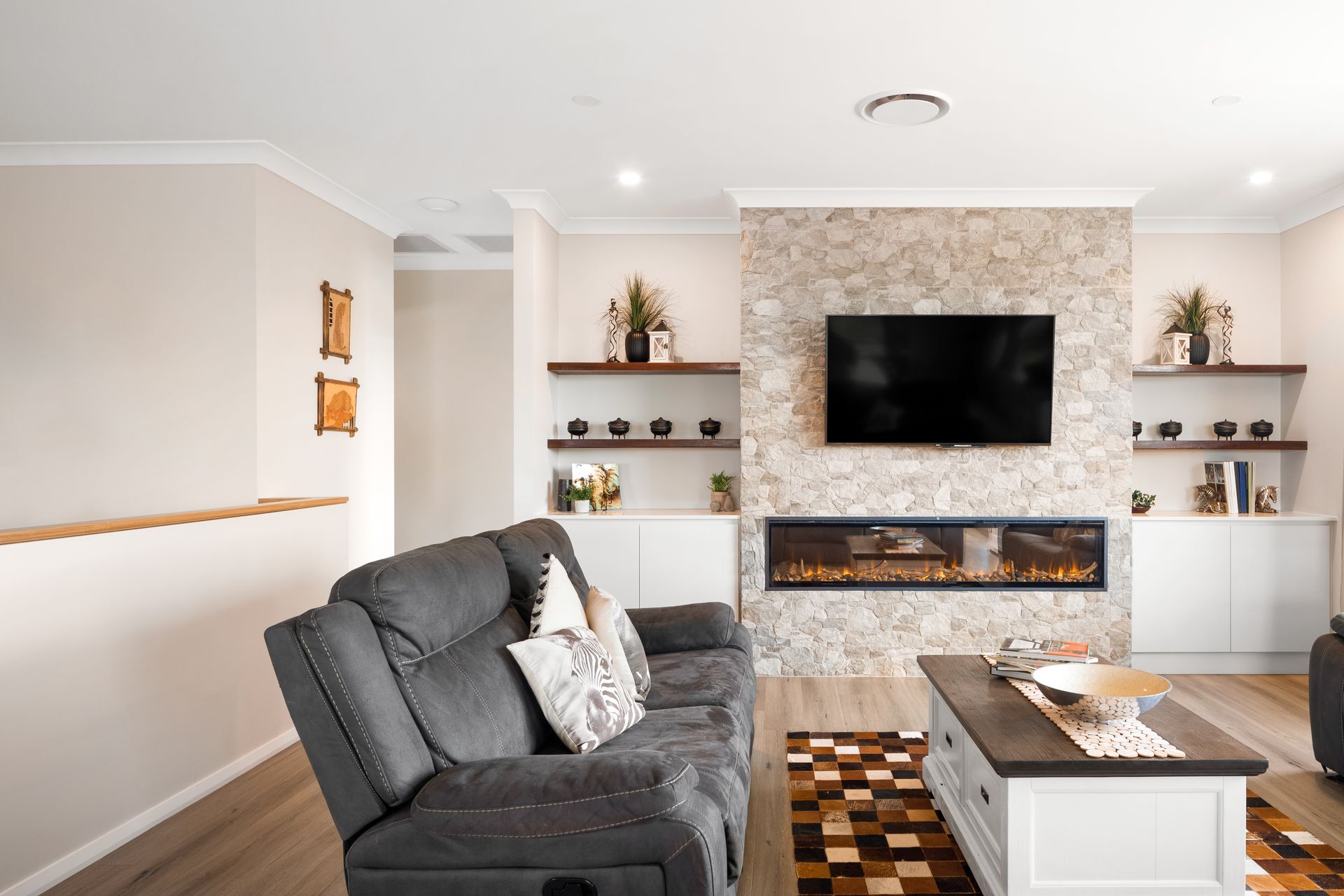 a living room with a couch , coffee table , television and fireplace .