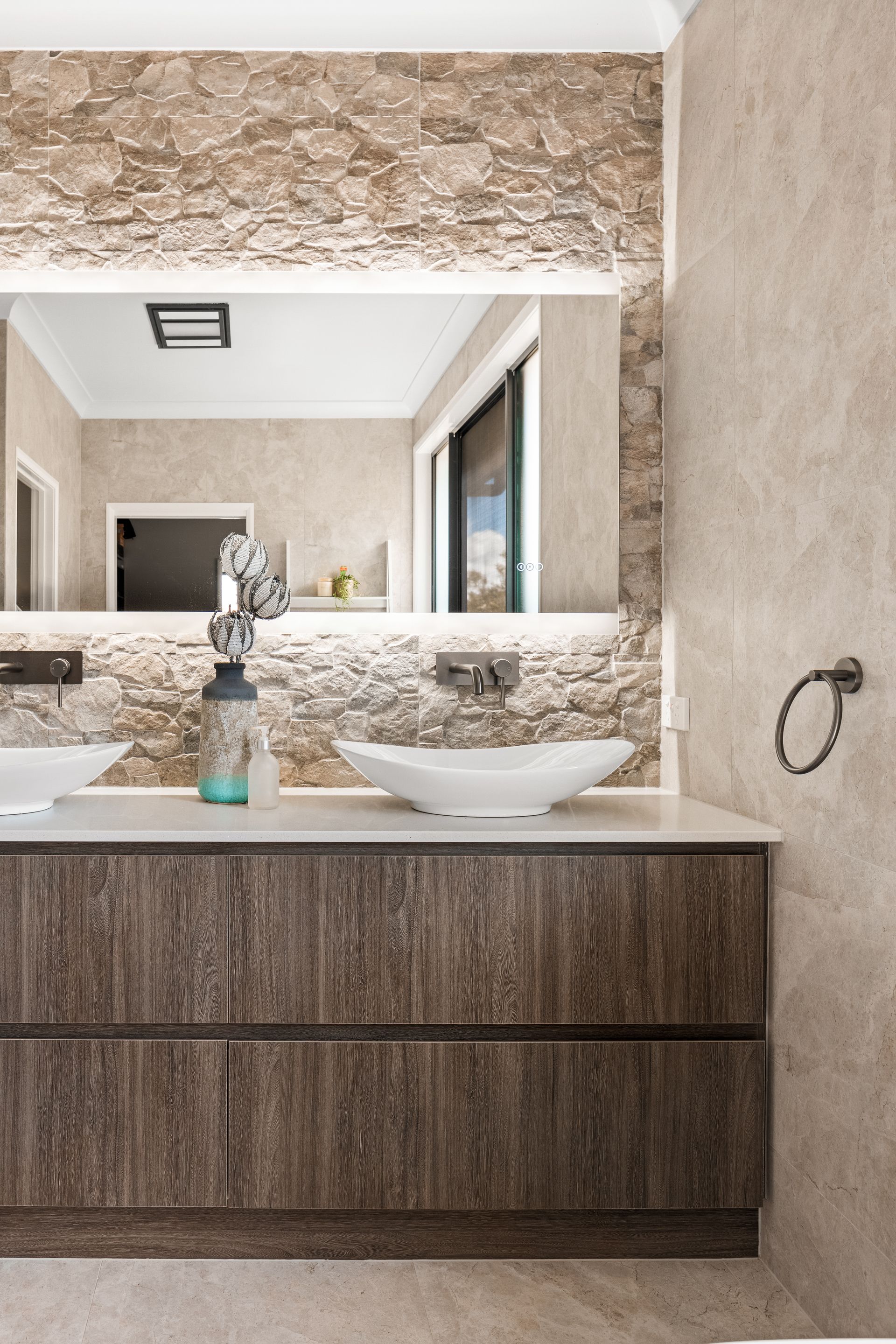 a bathroom with a sink and a large mirror .