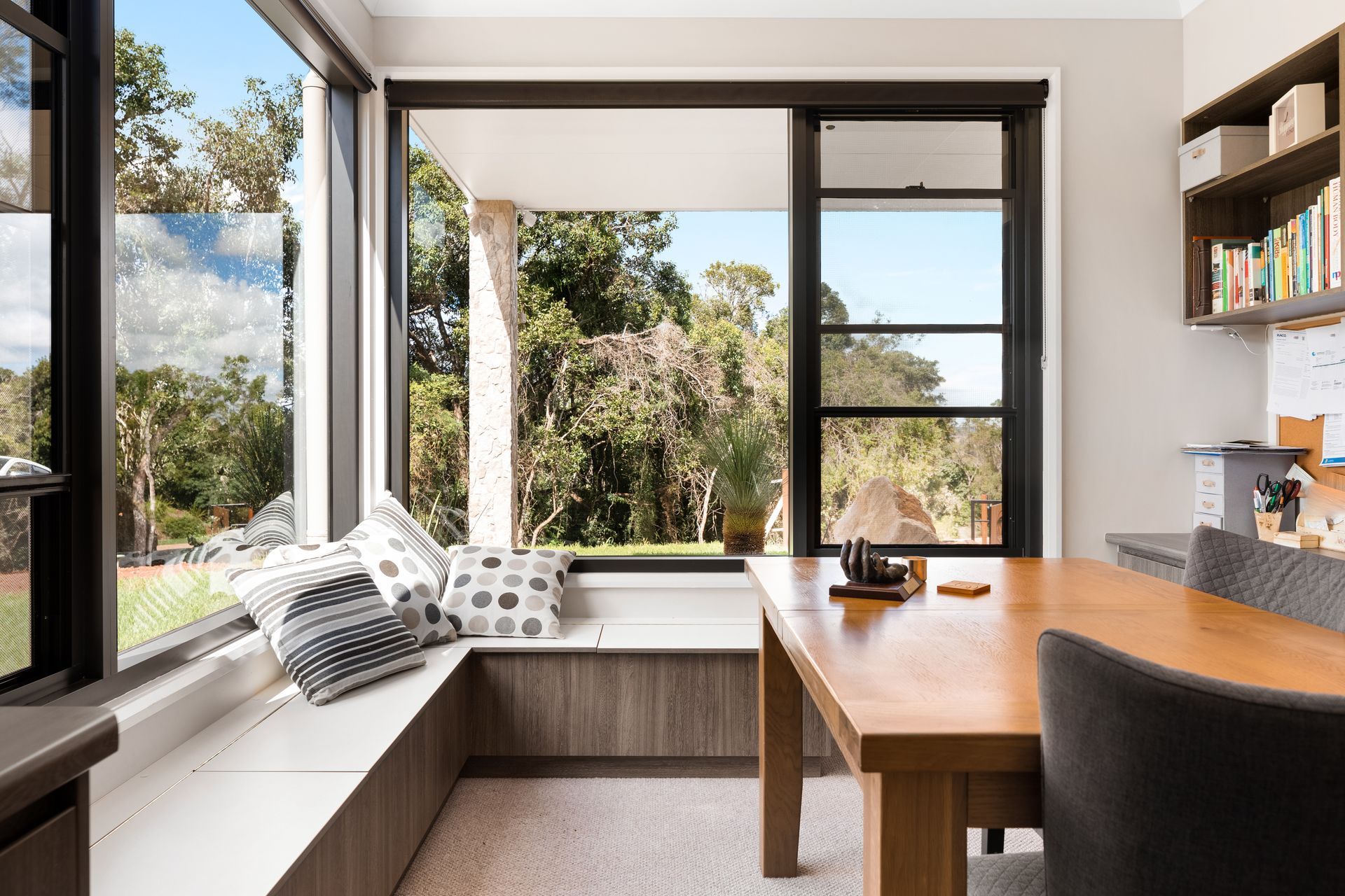 a dining room with a table and chairs and a window seat .