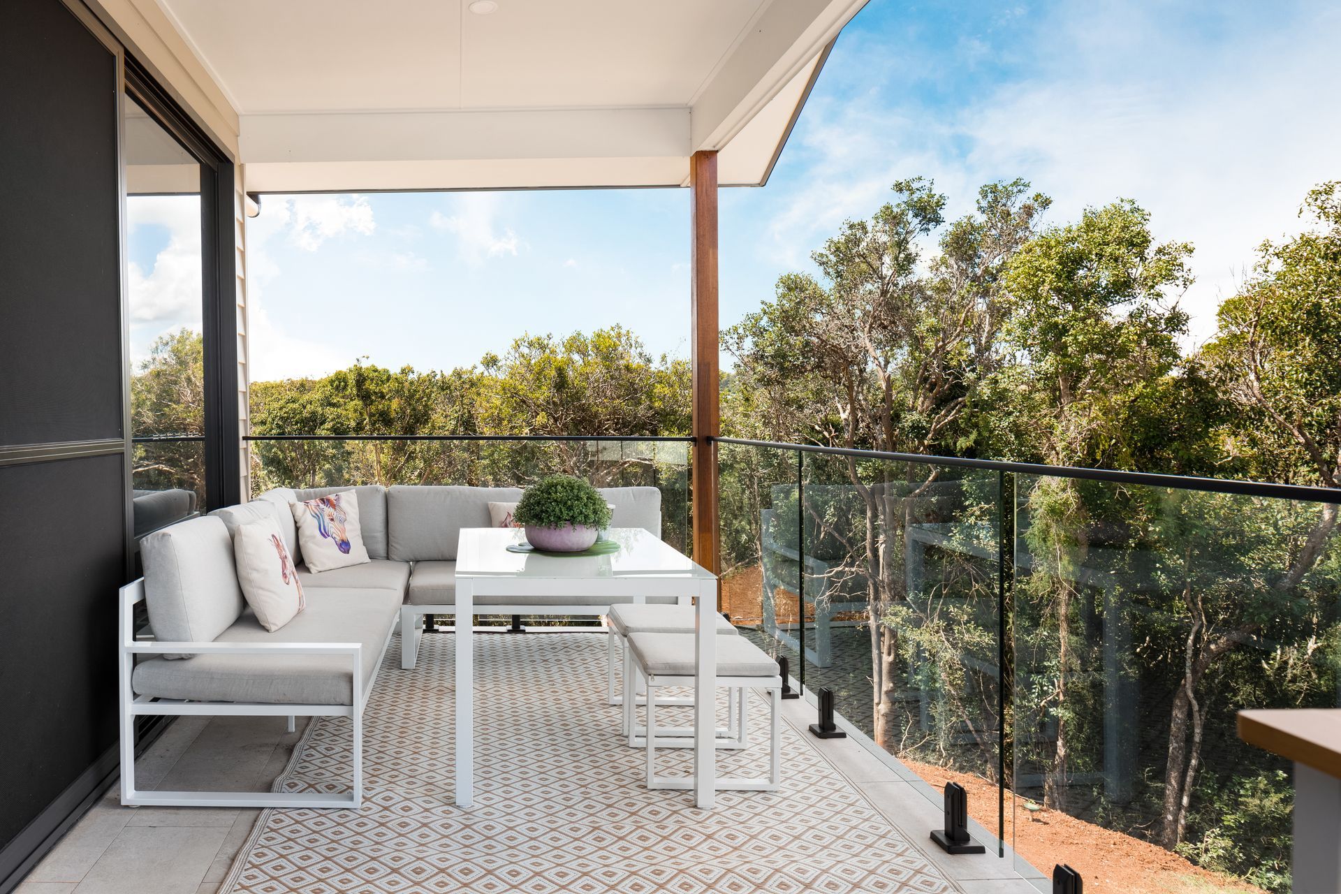 there is a balcony with a table and a couch on it .