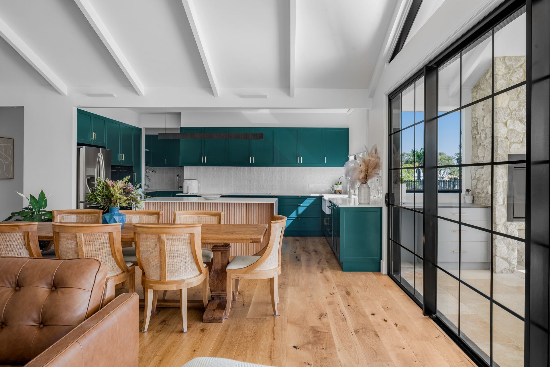 a living room with a dining table and chairs and a kitchen .