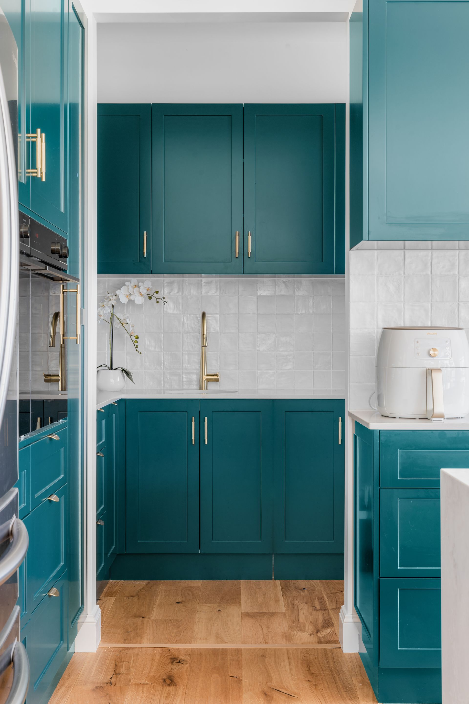 a kitchen with blue cabinets and a white counter top .