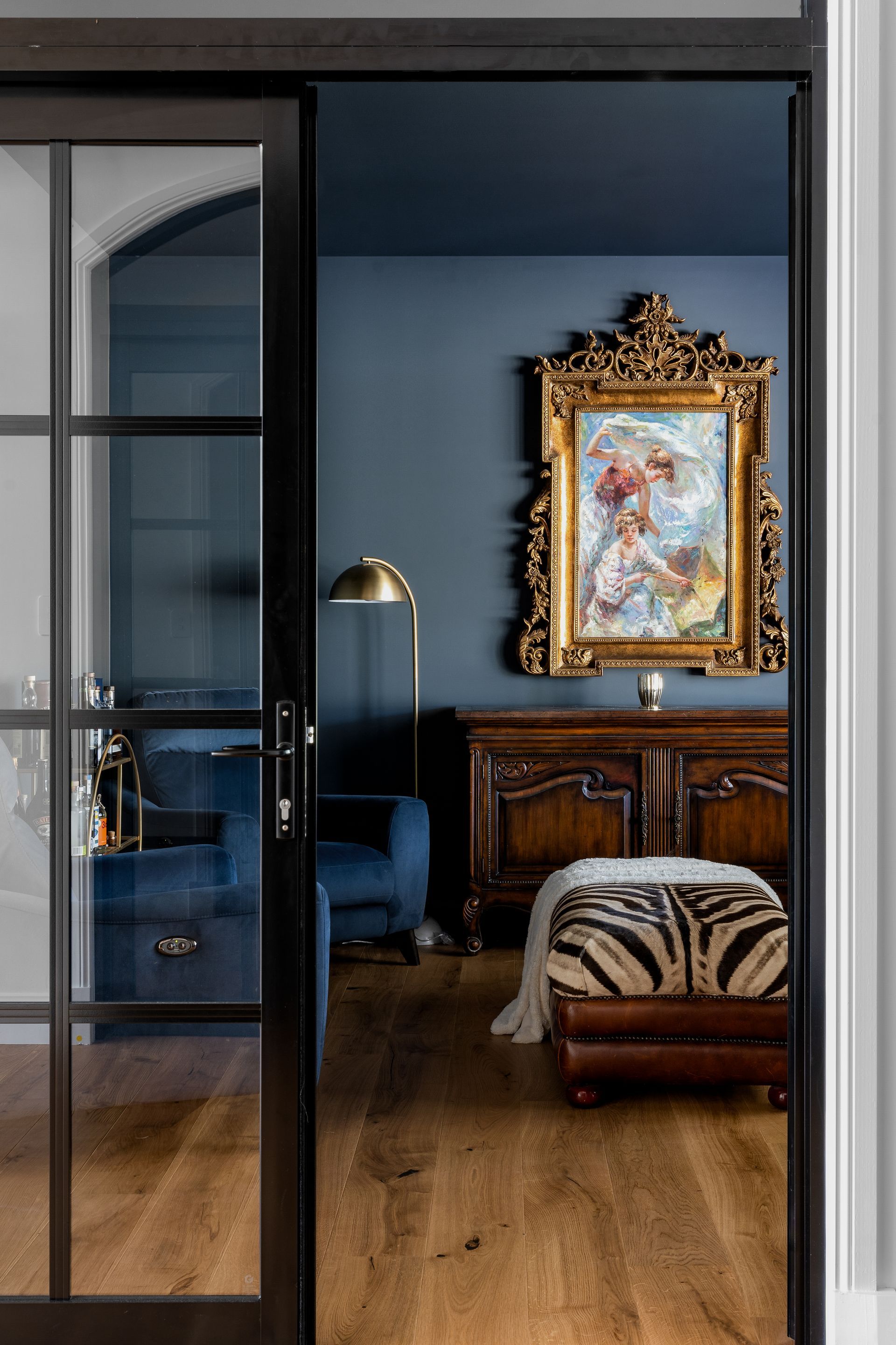 a living room with a sliding glass door and a painting on the wall .