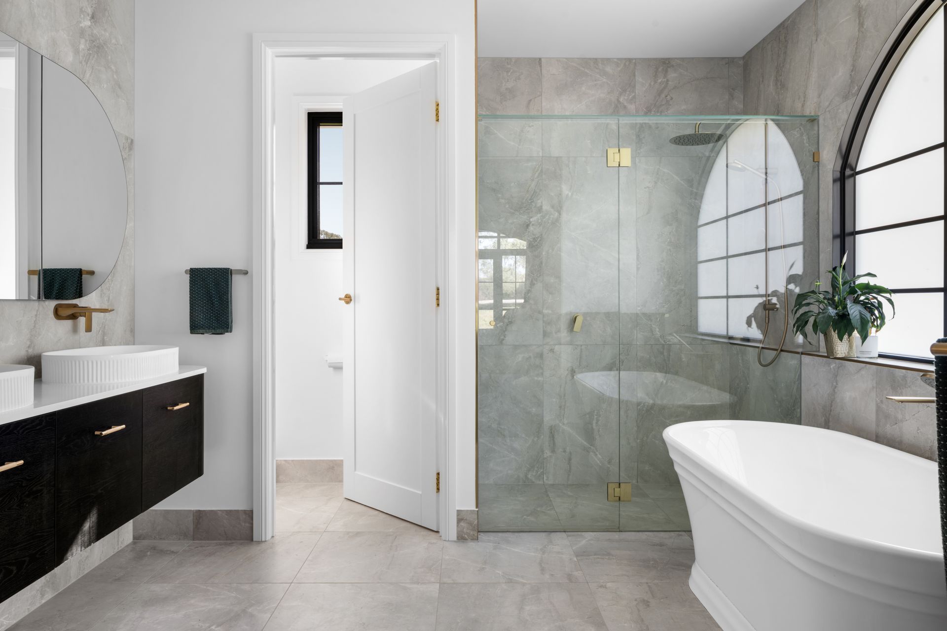 a bathroom with a tub , sink , mirror and walk in shower .