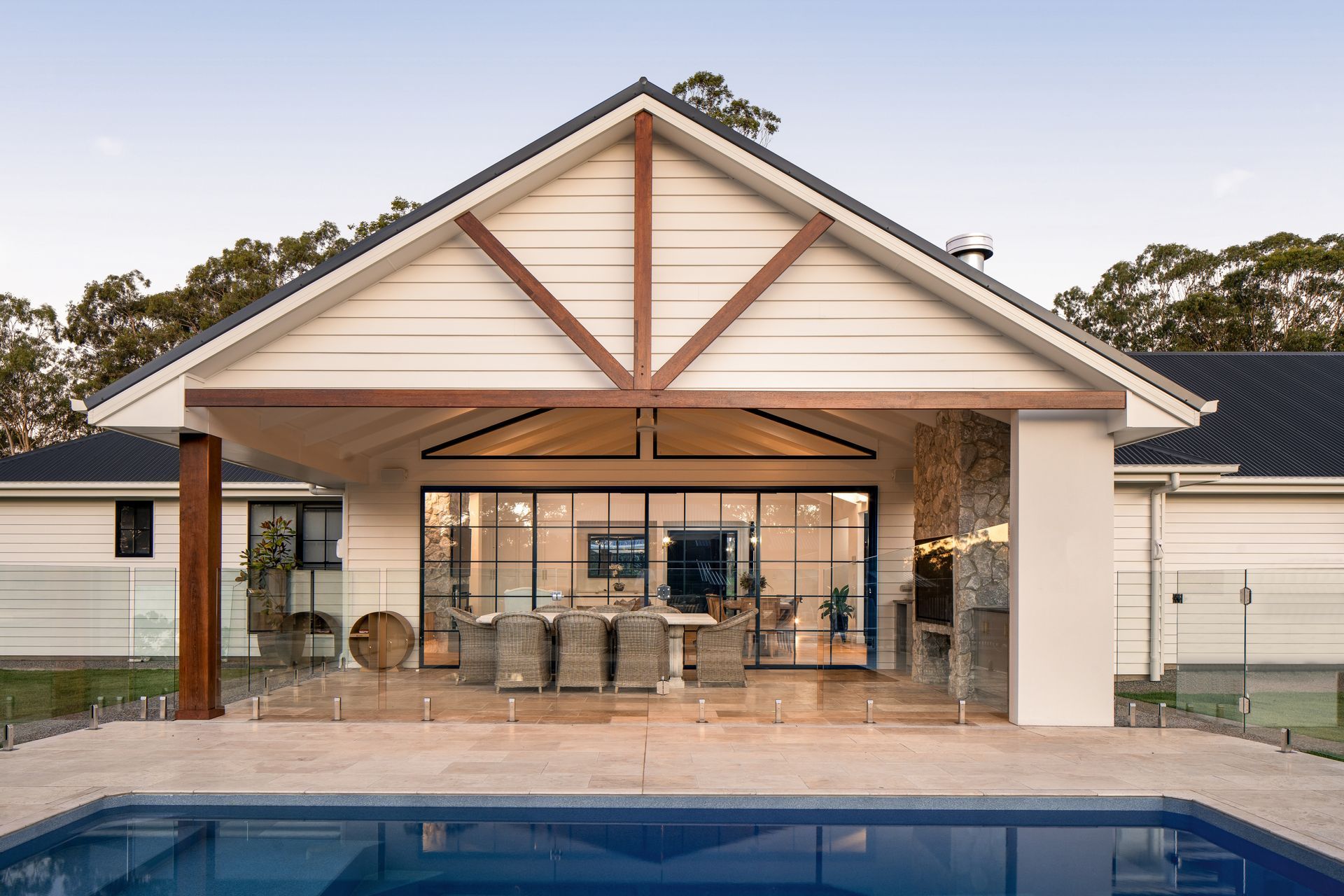 a large white house with a swimming pool in front of it .