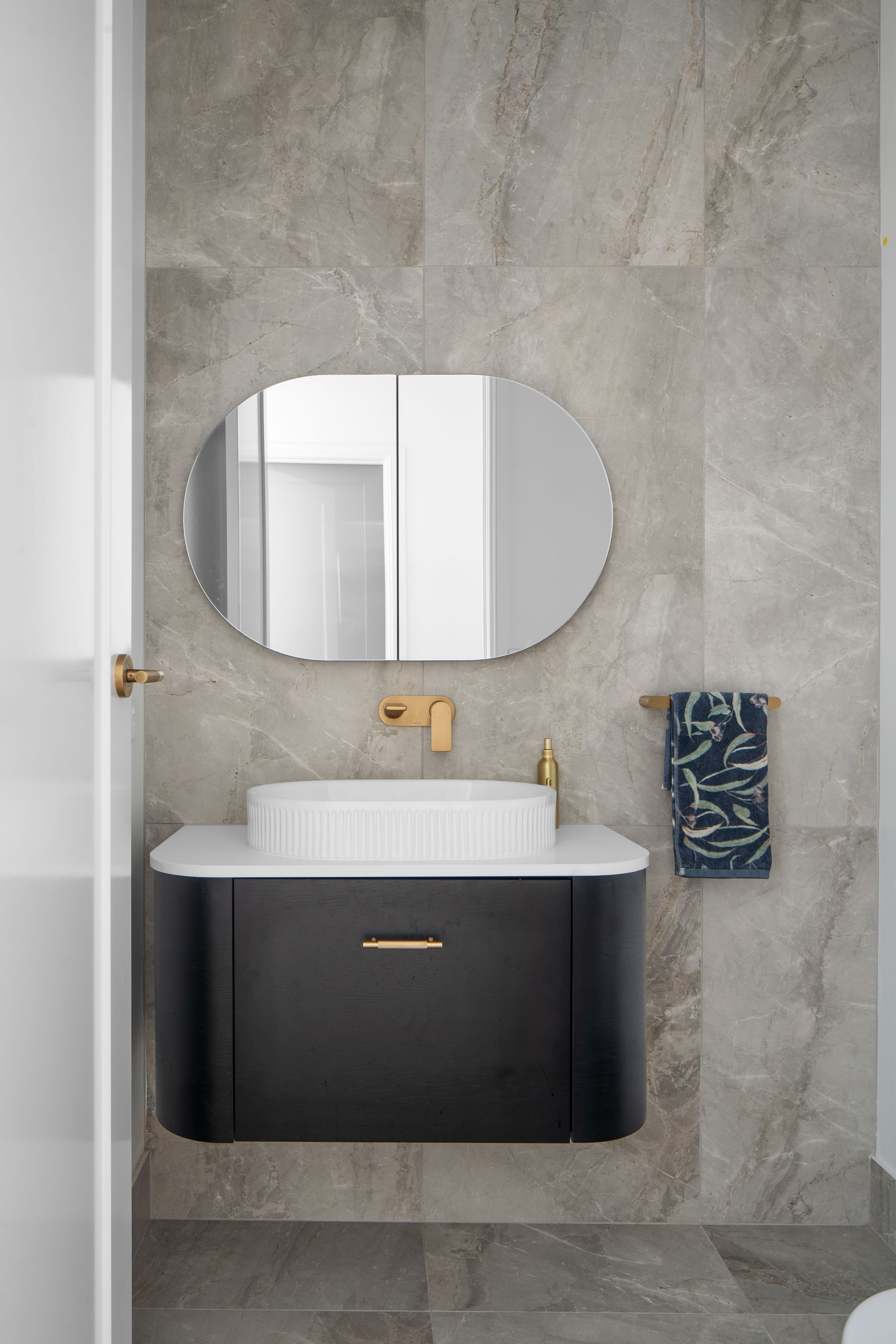 a bathroom with a sink , mirror and toilet .