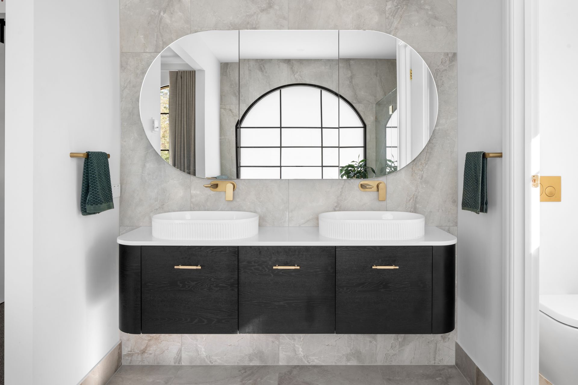 a bathroom with two sinks and a large mirror .