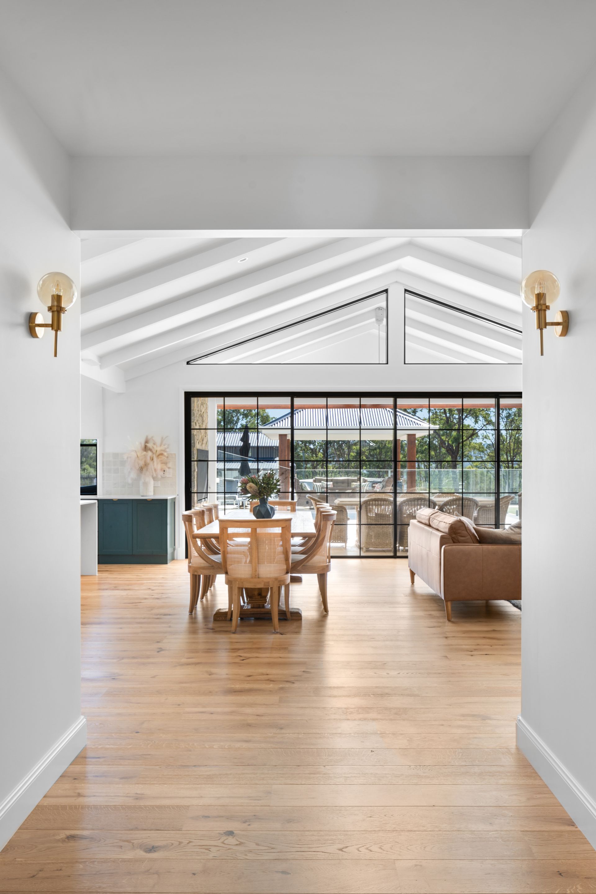 a hallway leading to a dining room and living room in a house .