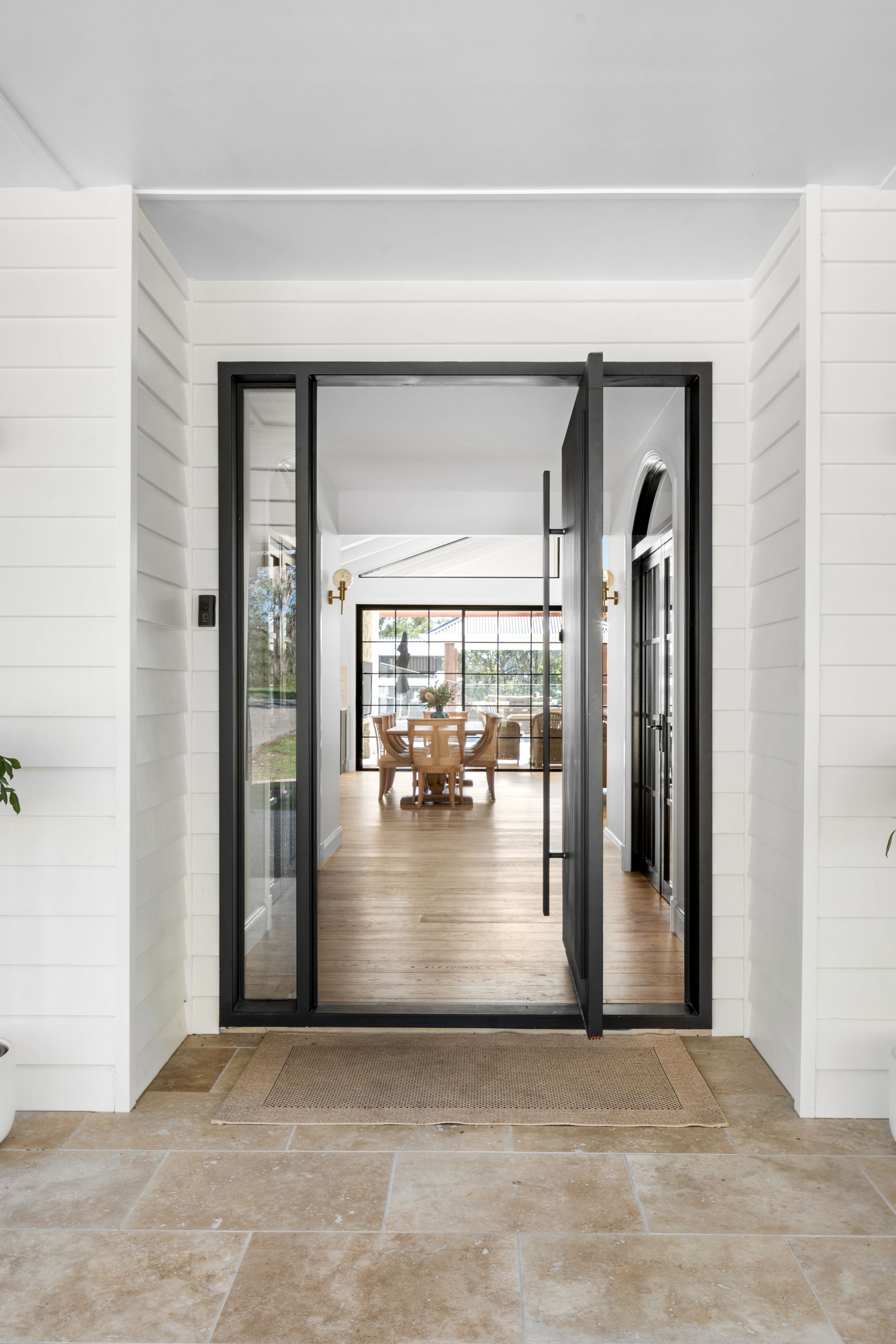 the front door of a house with a dining room in the background .