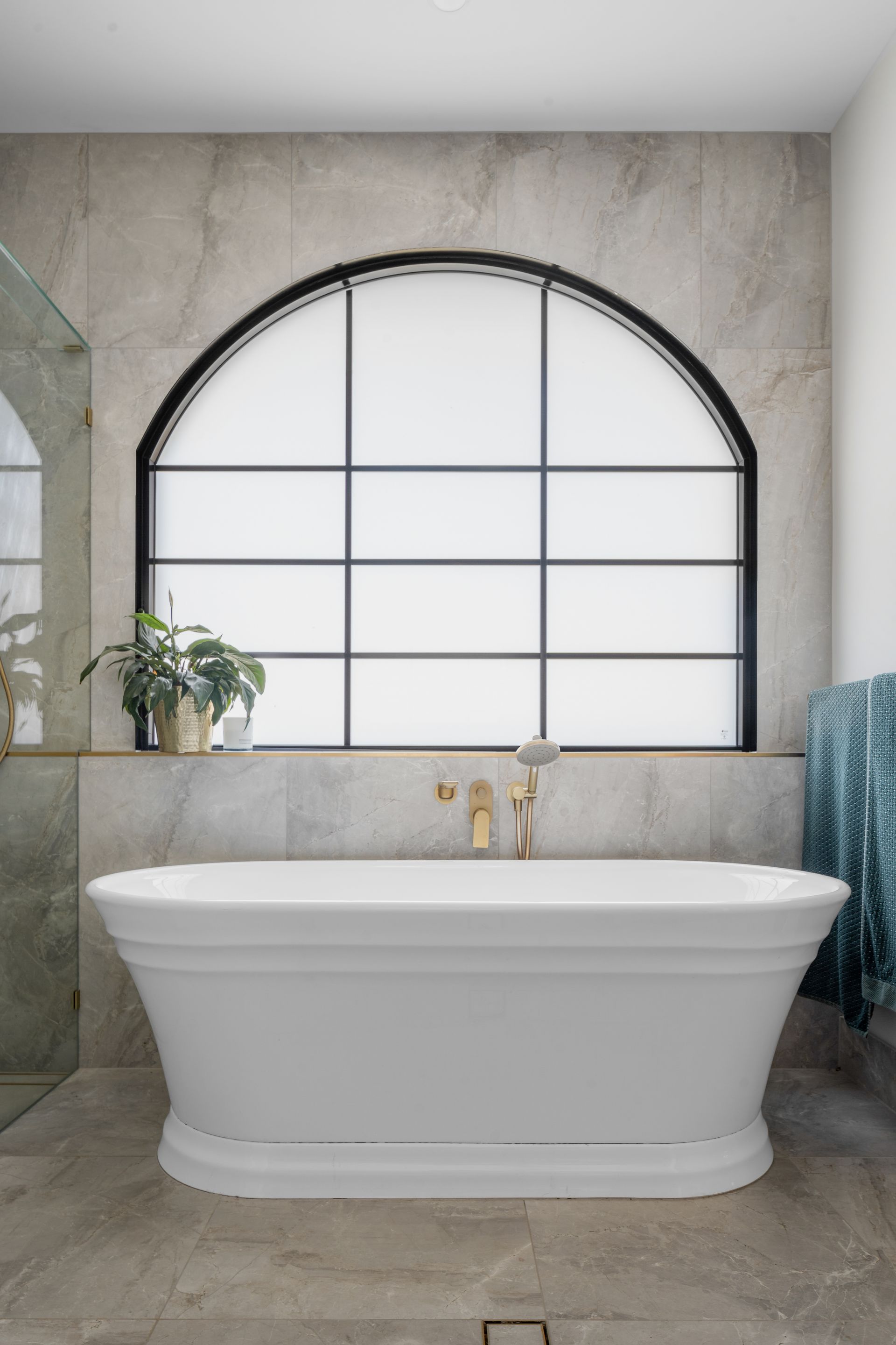 a bathroom with a bathtub and a large window .