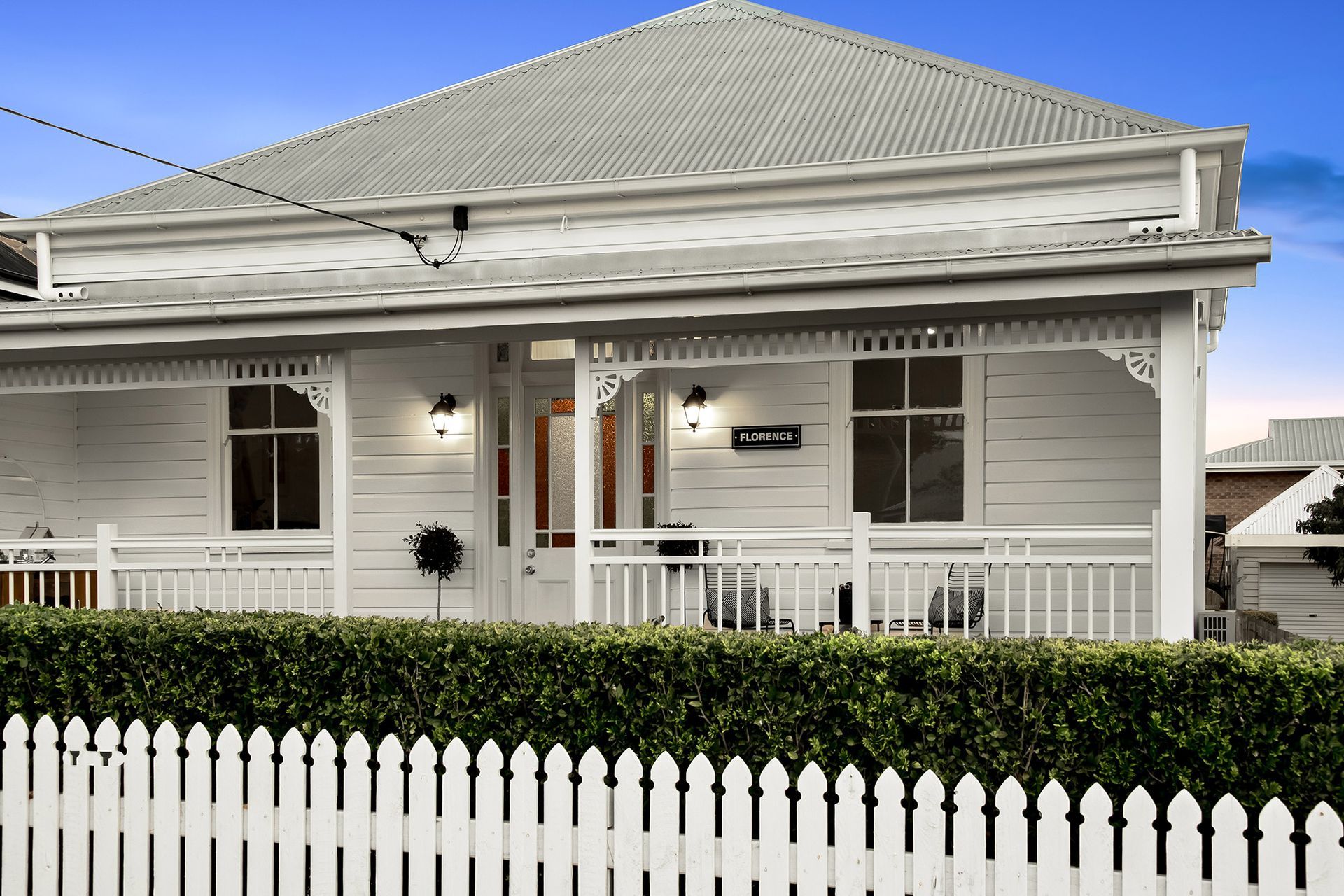 a white house with a white picket fence around it