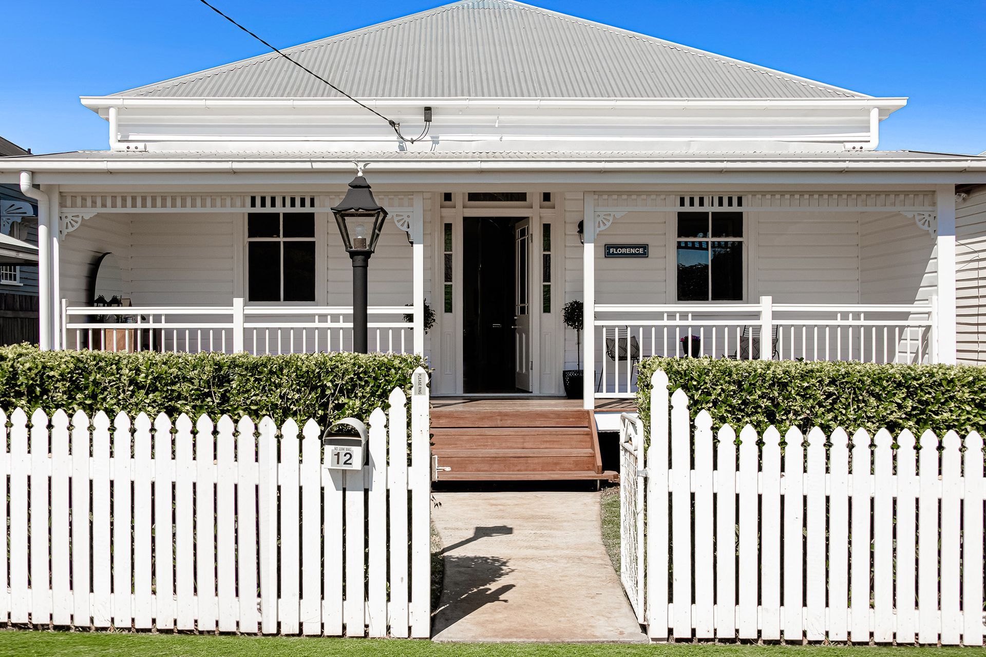a white house with a white picket fence around it