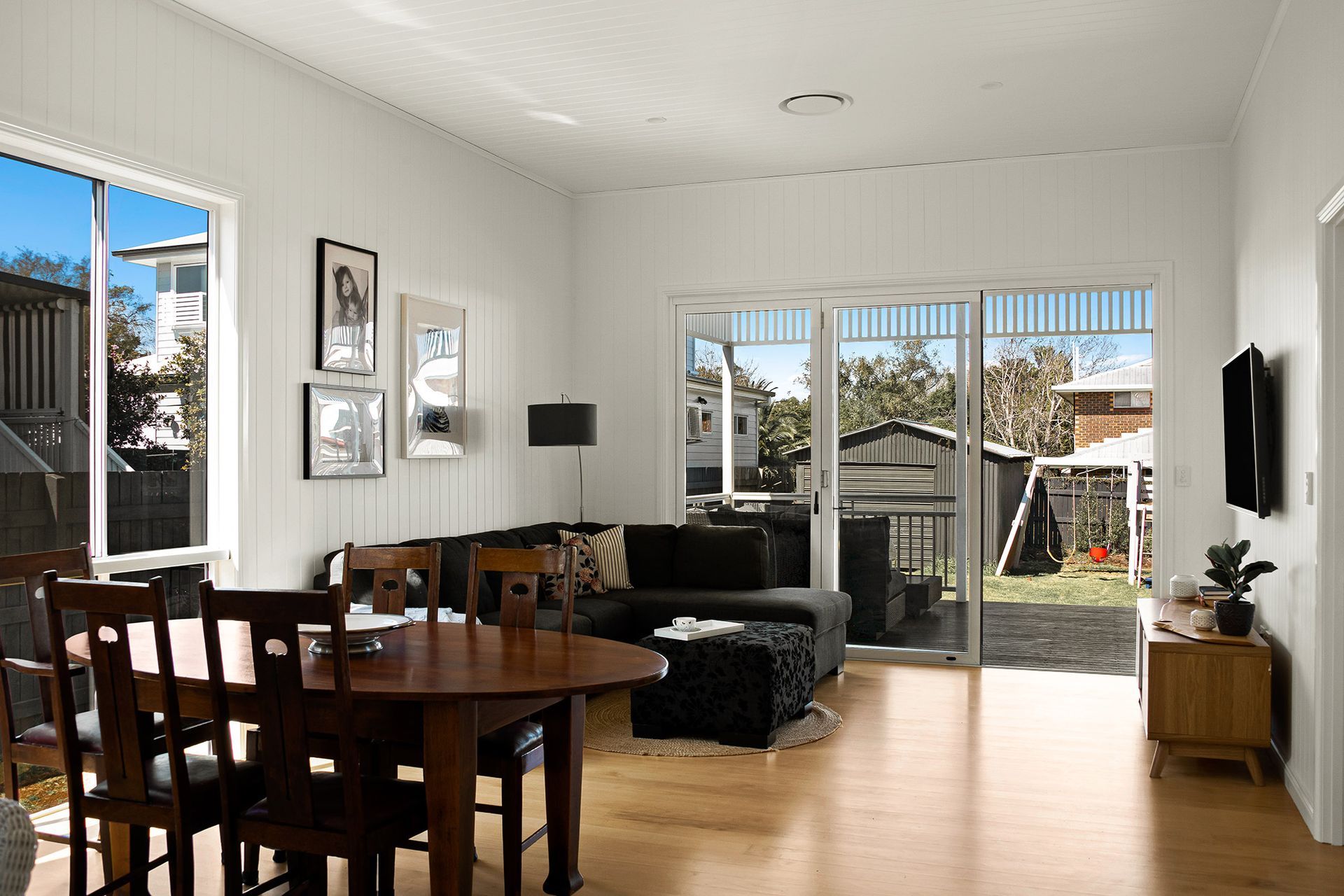 a living room with a dining table and chairs and a couch .