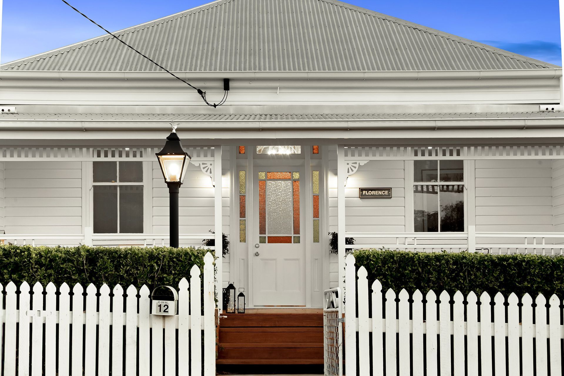 a white house with a white picket fence around it