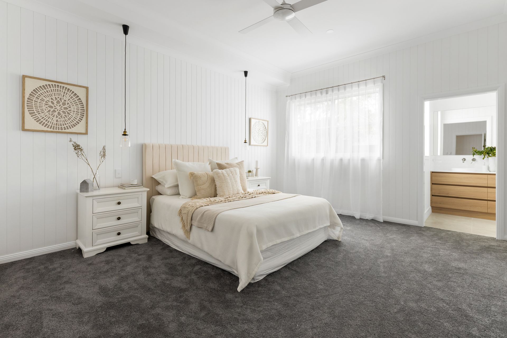 a bedroom with a bed , nightstand , dresser and ceiling fan .