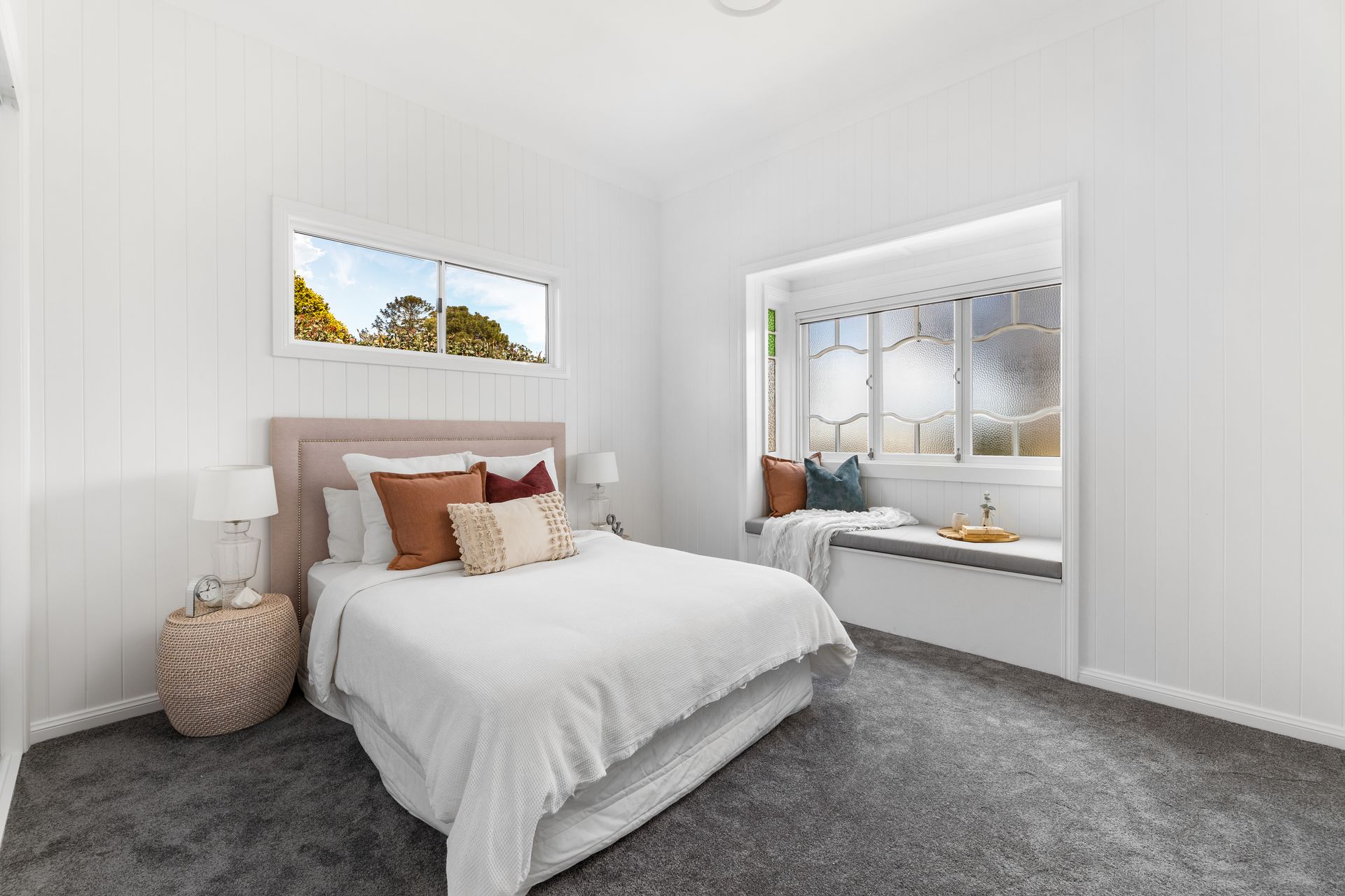 a bedroom with a bed and a window seat .