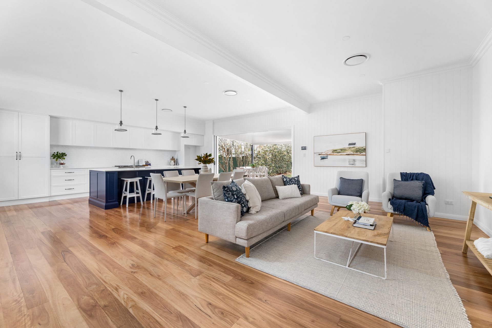 a living room with a couch , chair , table and rug .