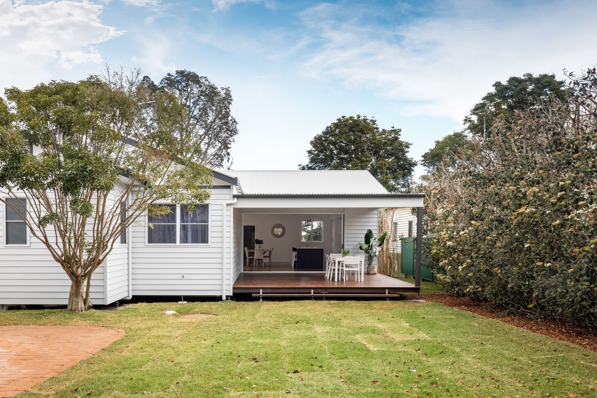 a white house with a large lawn in front of it
