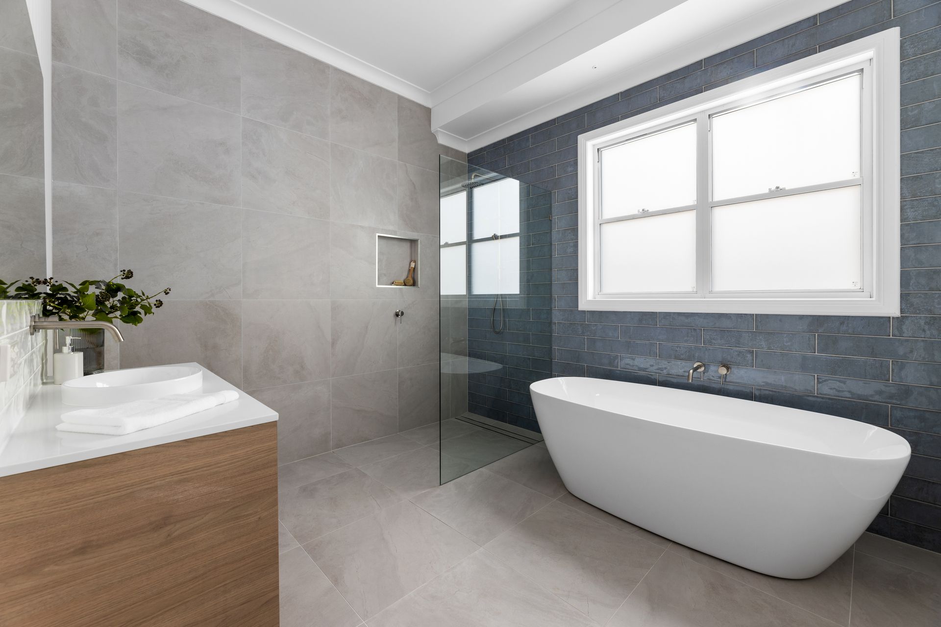 a bathroom with a bathtub , sink , and shower .