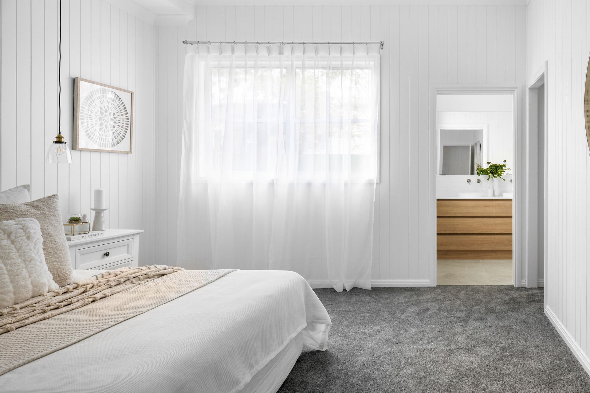 a bedroom with a bed , nightstand , window and carpet .