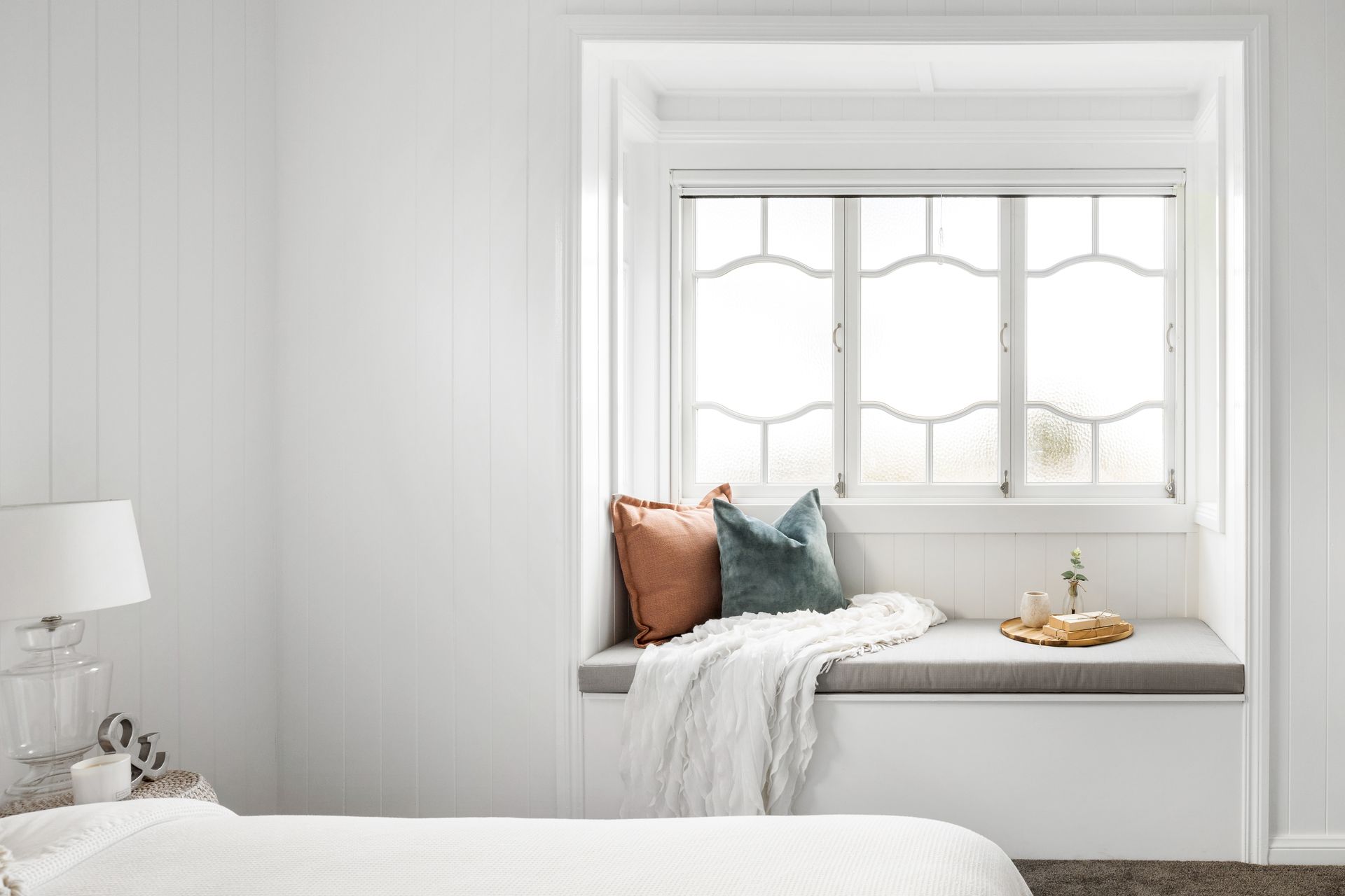 a bedroom with a window seat and a bed .