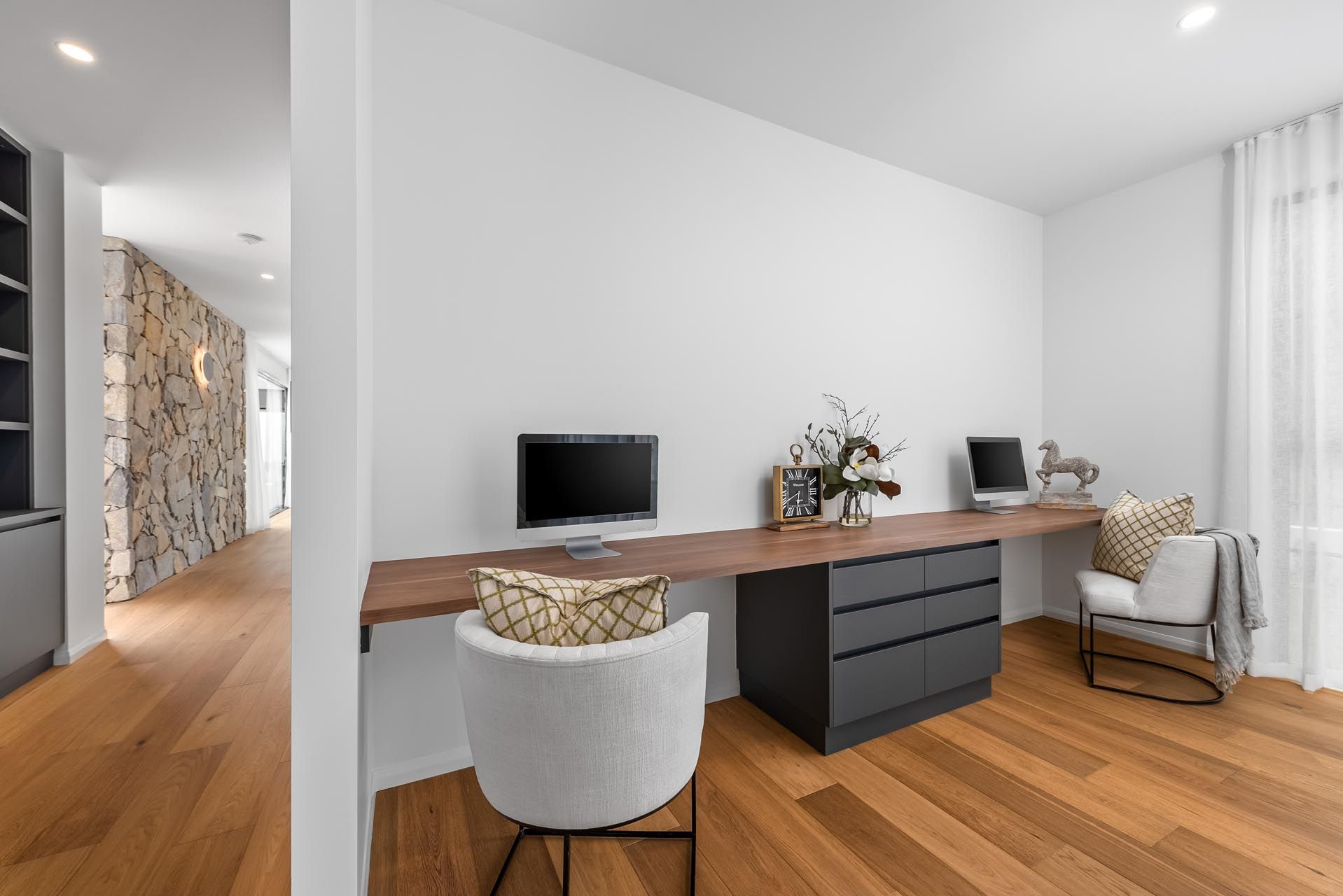 There is a desk with a computer on it in the room.