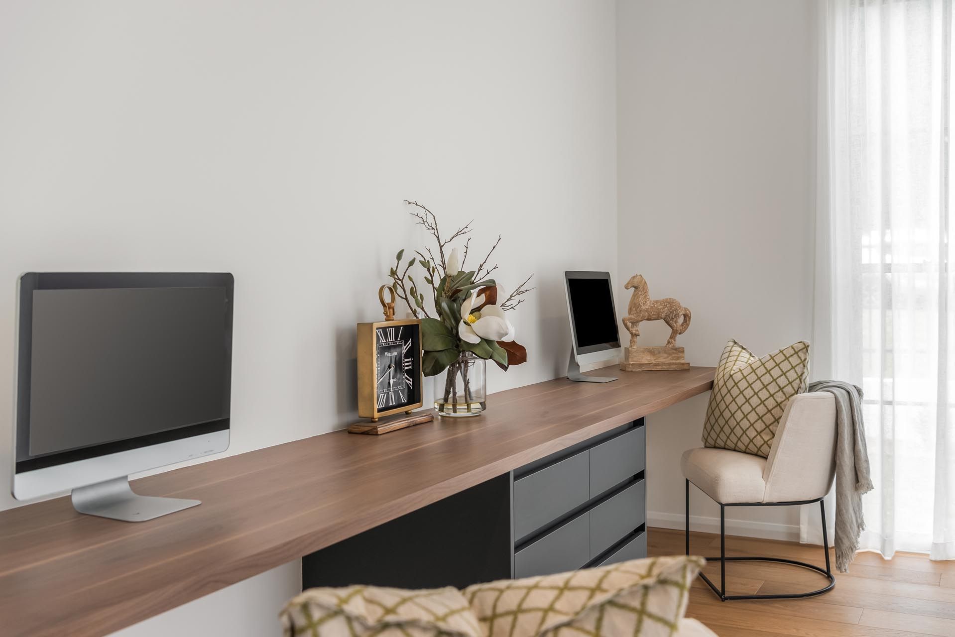 There is an office area with a desk that has a computer on it.