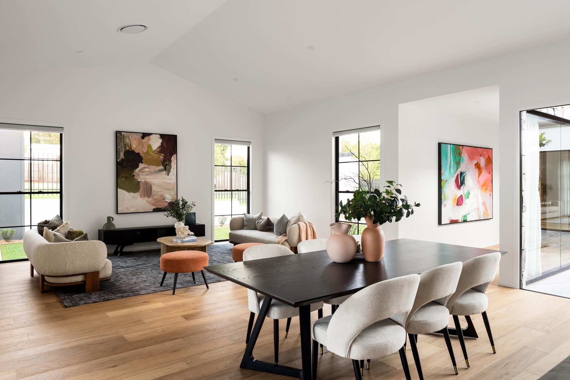 There is a dining table and chairs in the middle of the room.