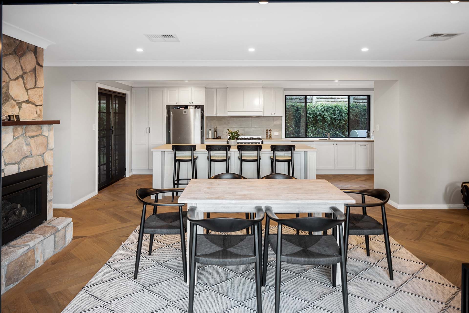a dining room with a table and chairs and a fireplace .