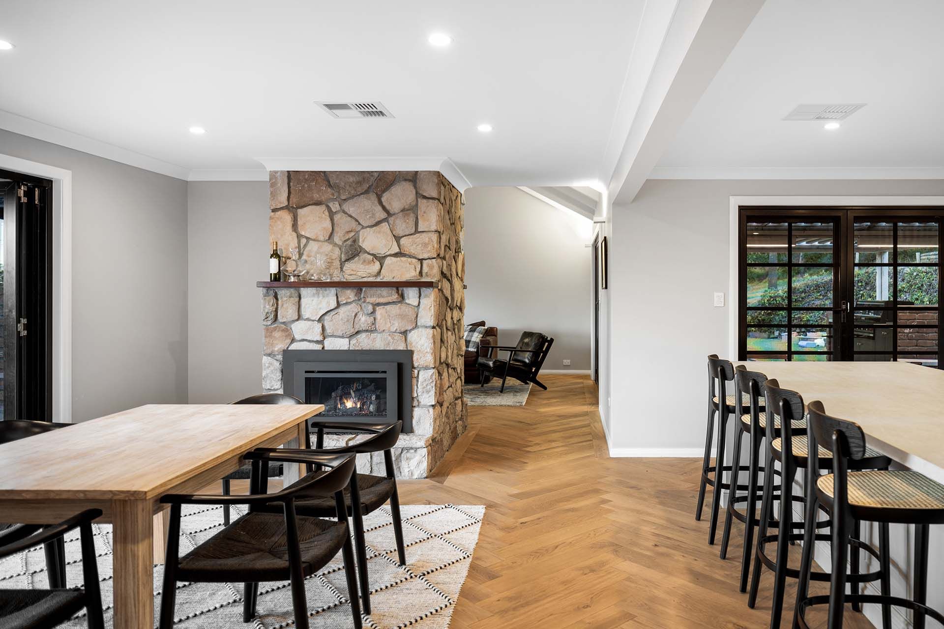 a dining room with a table and chairs and a fireplace .