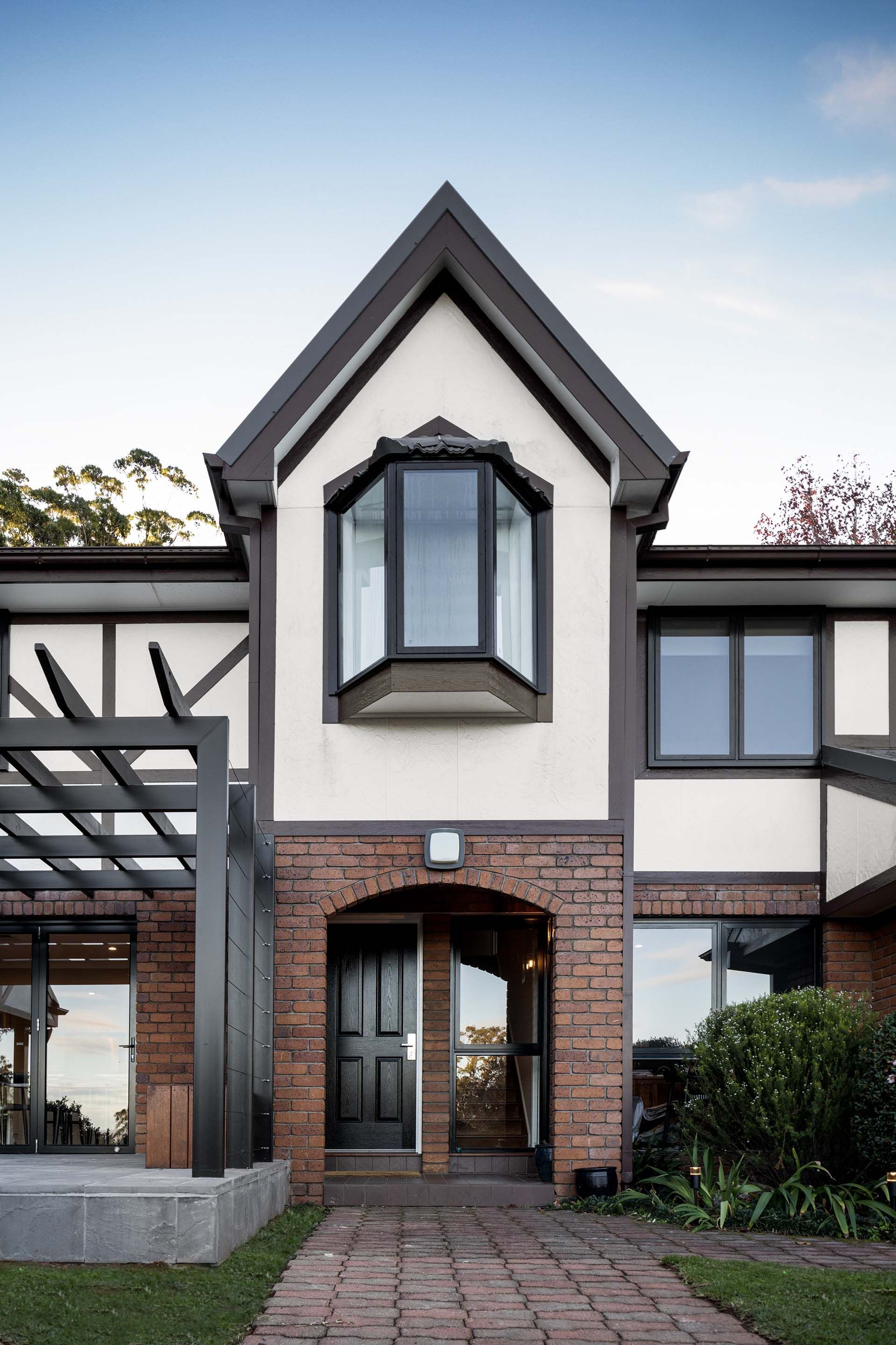 the front of a house with a brick walkway leading to it