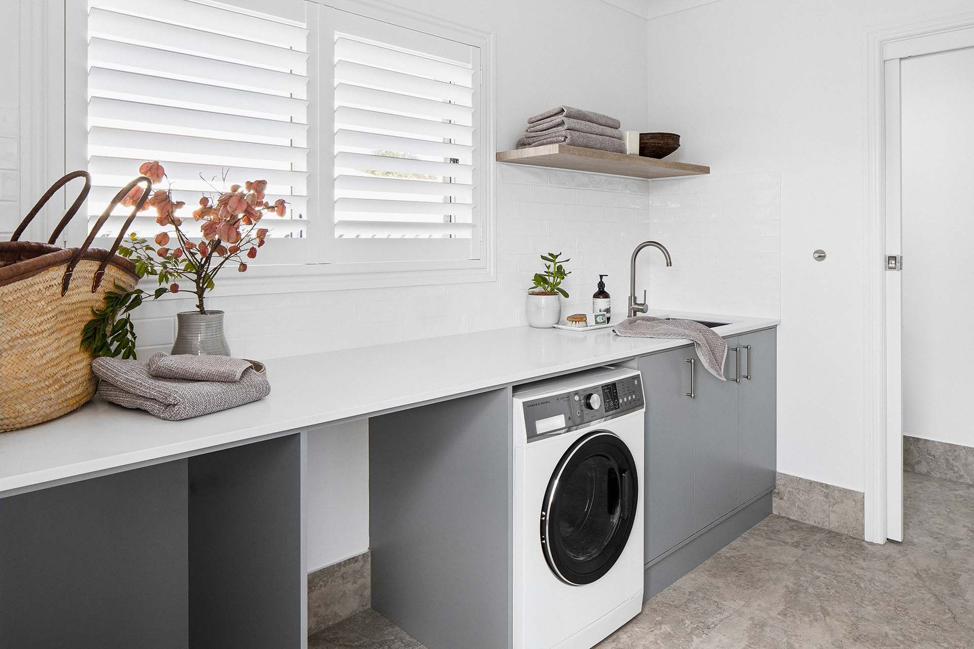 a laundry room with a washing machine and a sink .