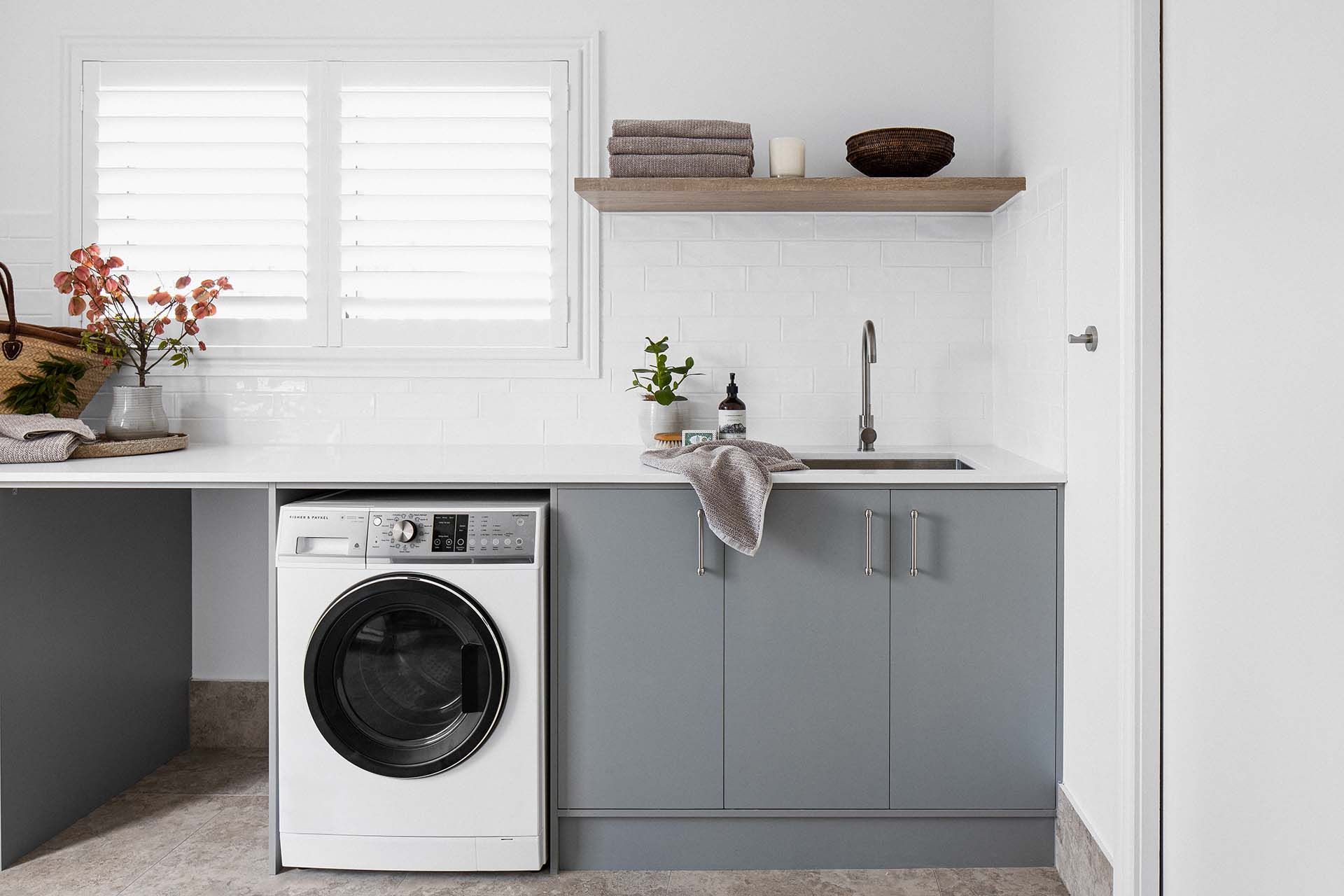 a laundry room with a washer and dryer and a sink .