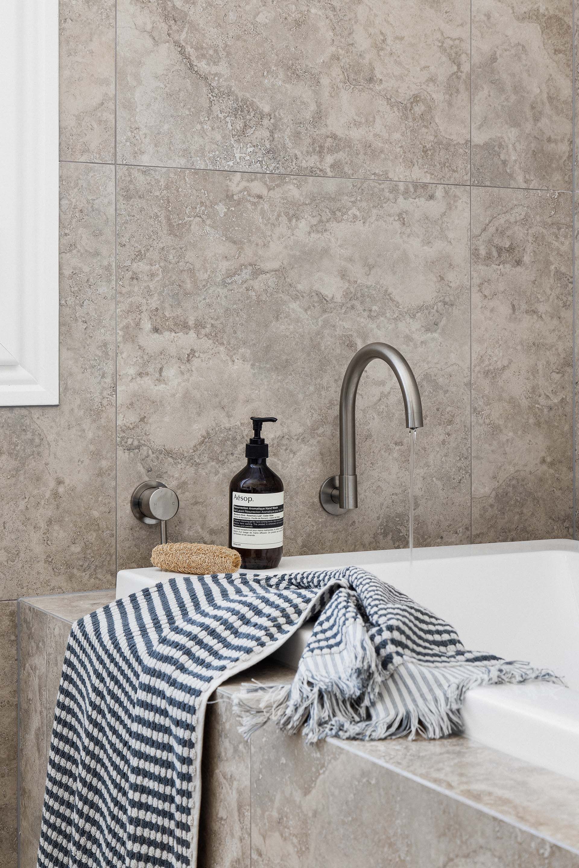 a bathroom with a bathtub and a towel on the counter .