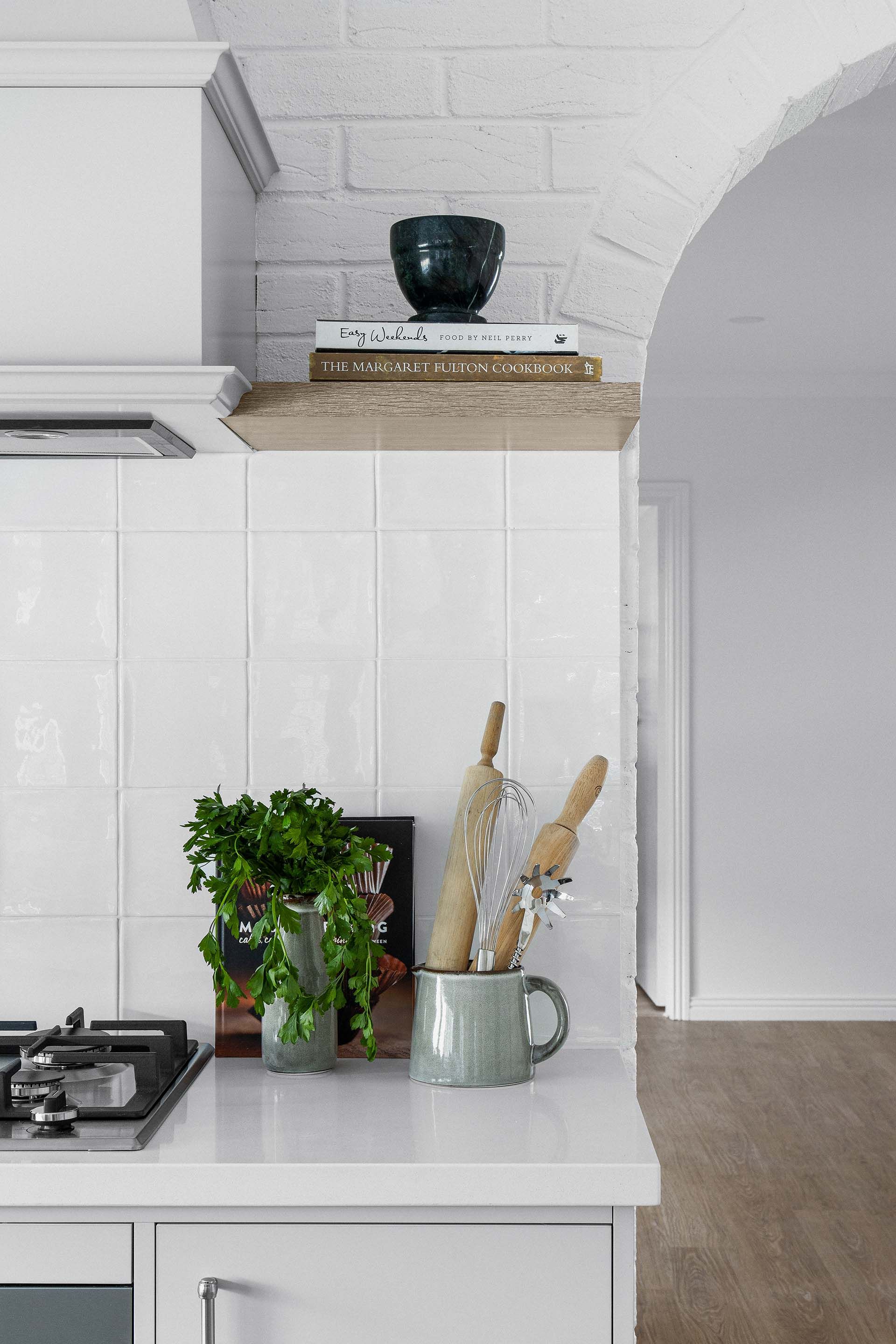 a kitchen with white cabinets and a stove top oven 