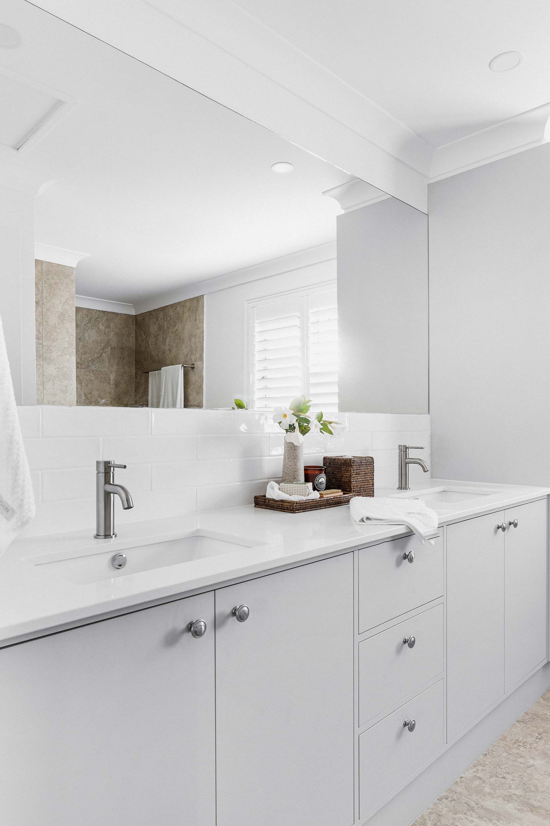 a bathroom with two sinks and a large mirror .