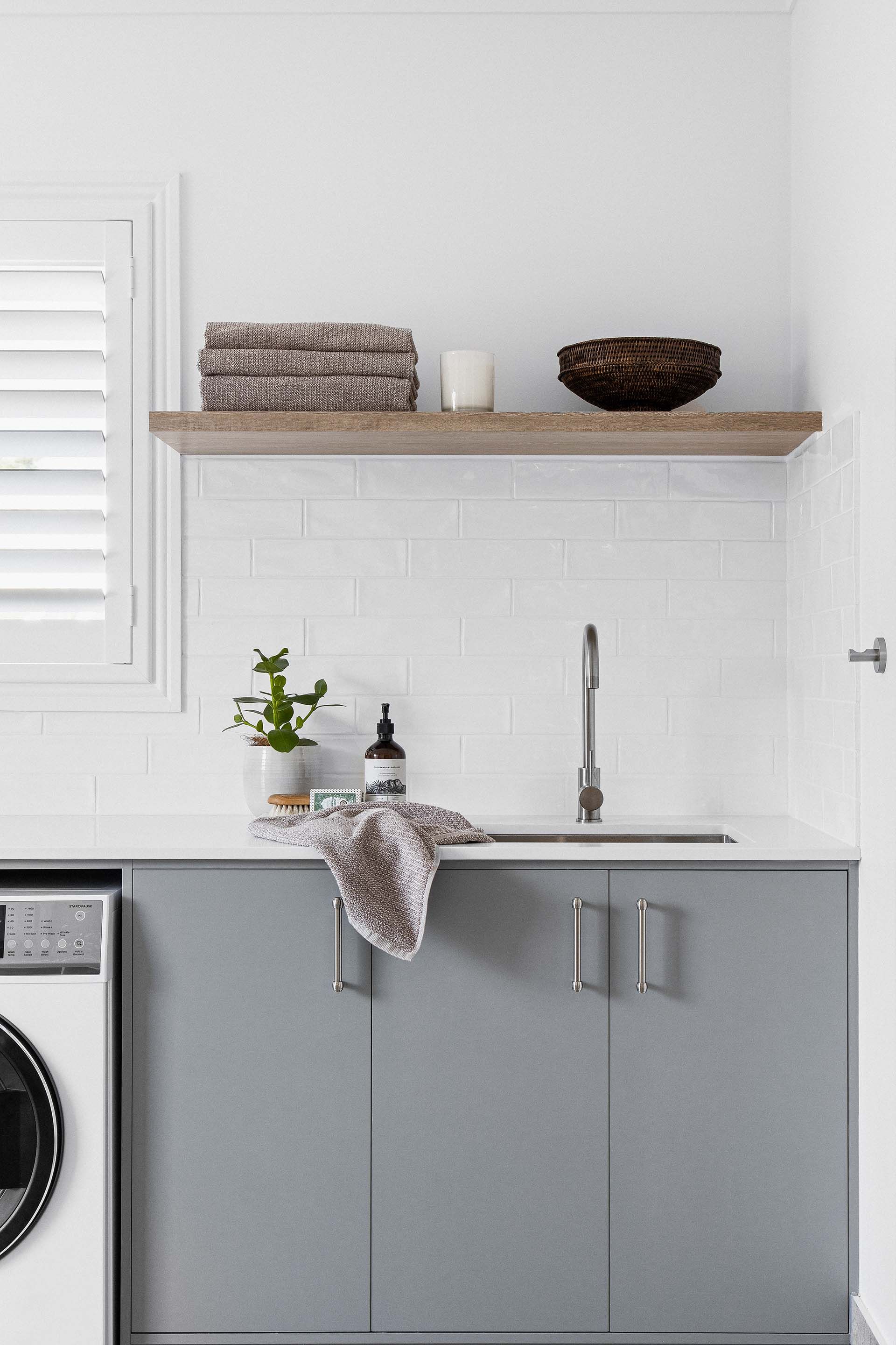 a laundry room with a sink , washer and dryer .