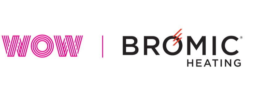 Overhead view of two people working at a curved counter with built-in lights, plants below.